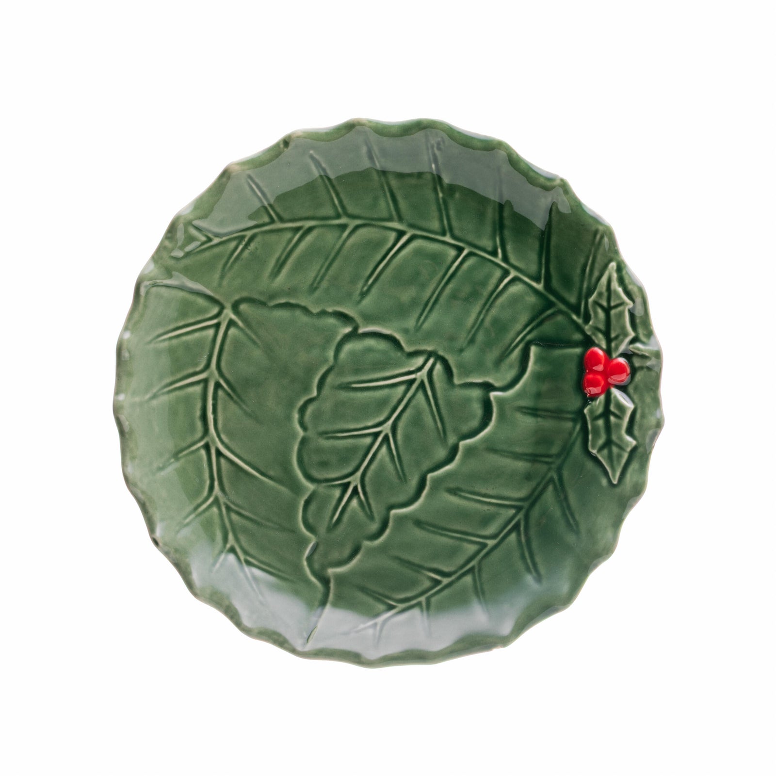 Green ceramic plate with green holly and red berry design on a white background