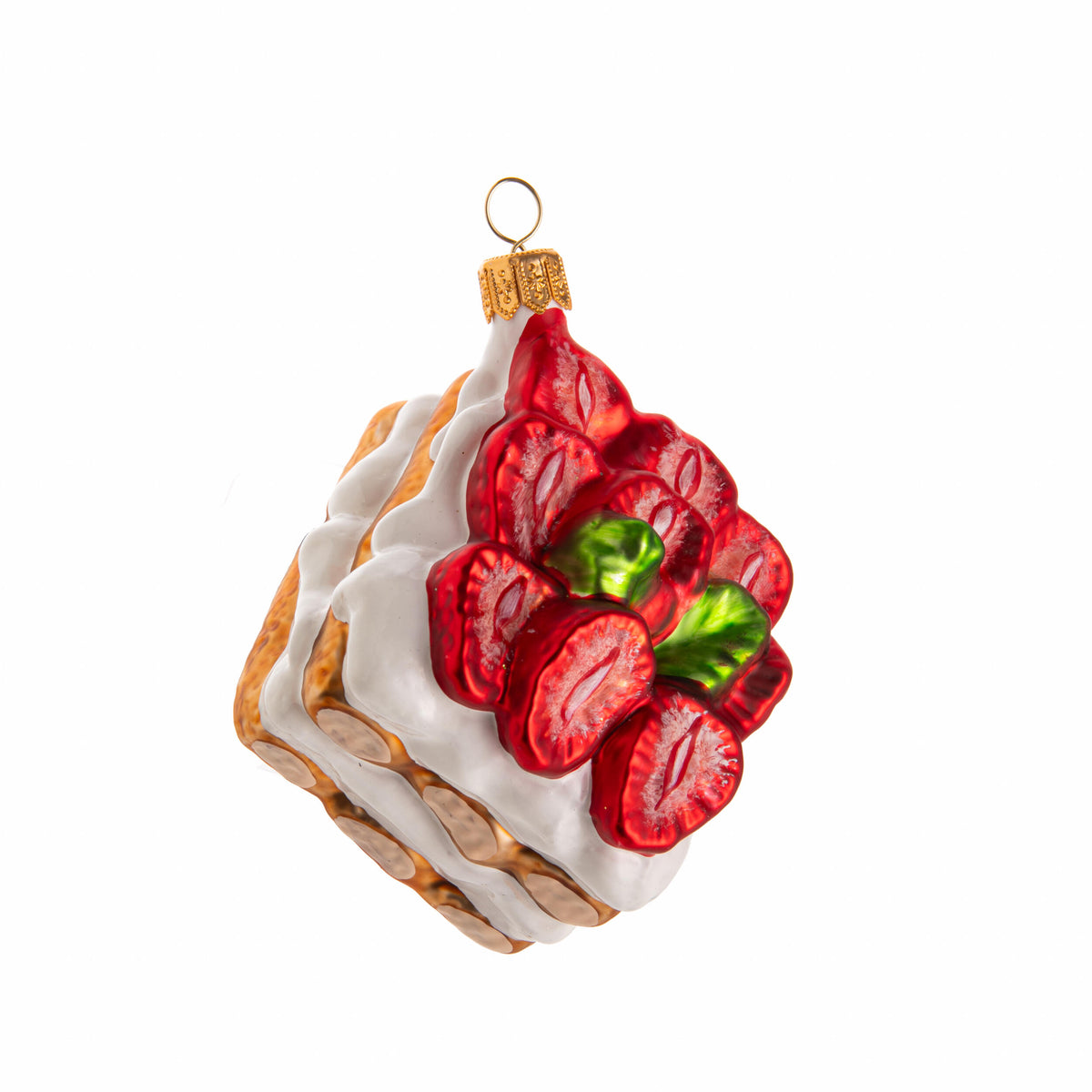 Decorative ornament shaped like a strawberry tart with white icing on a white background
