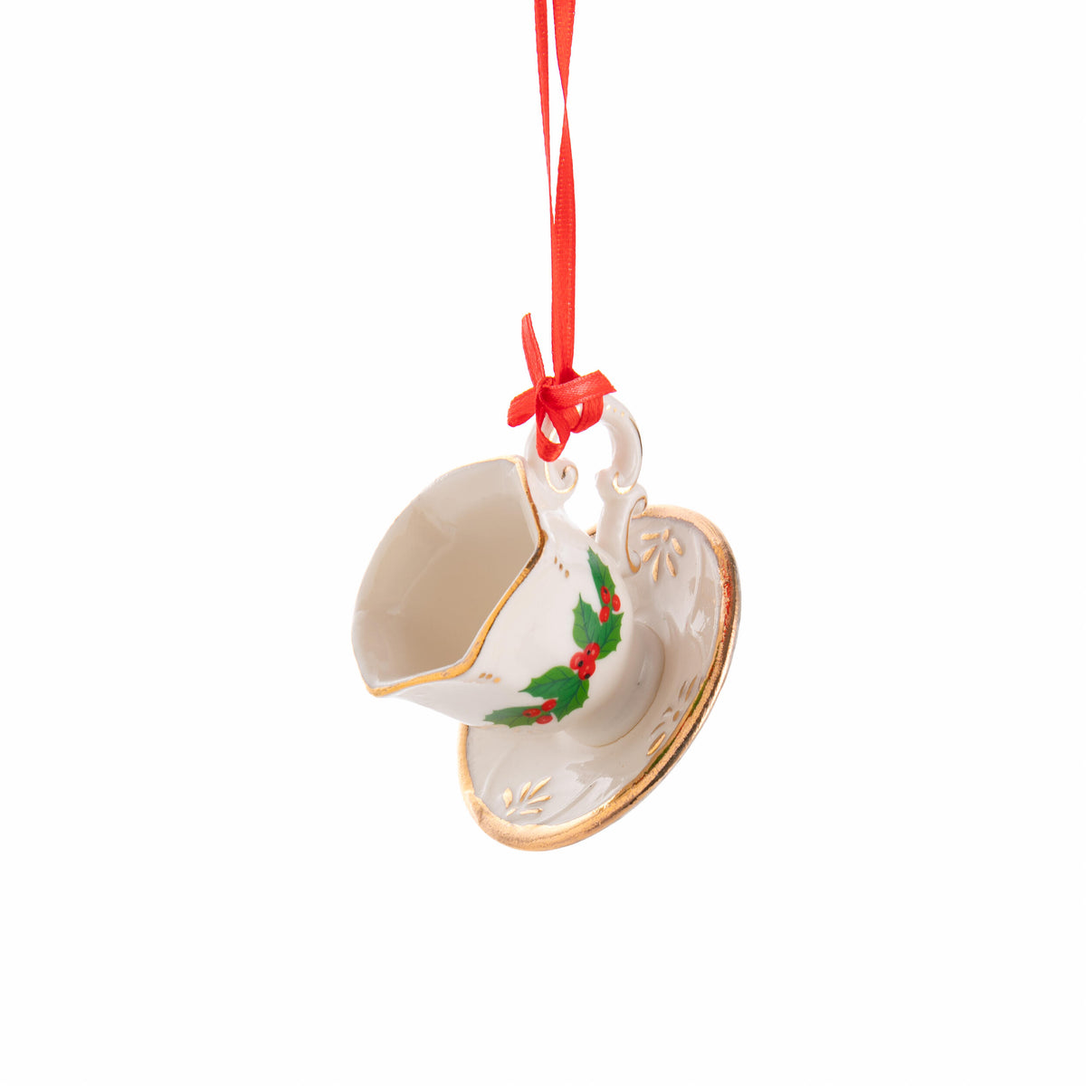 Decorative teacup ornament with holly design on a white background