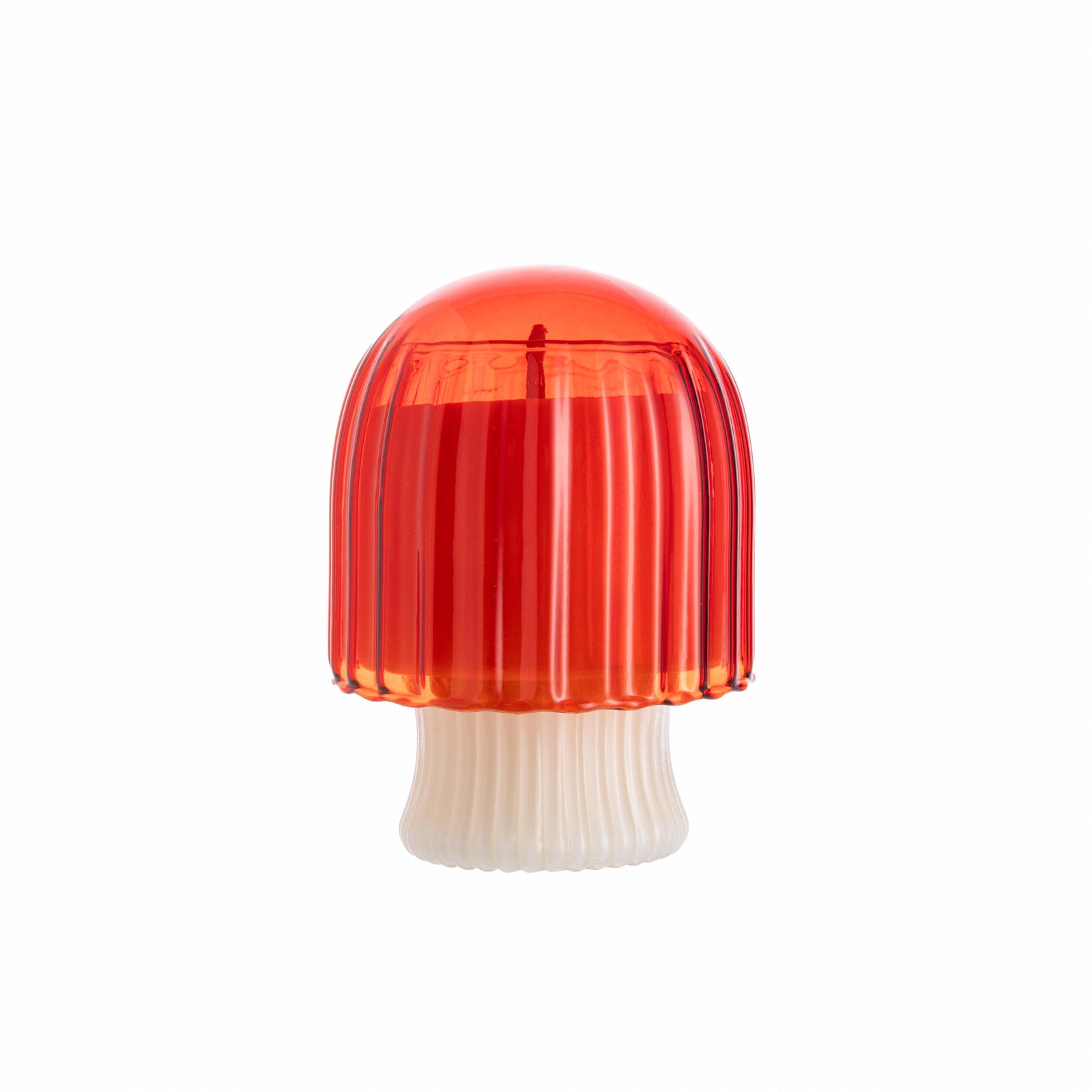 Red mushroom-shaped glass candle holder with scented candle inside, on a white background