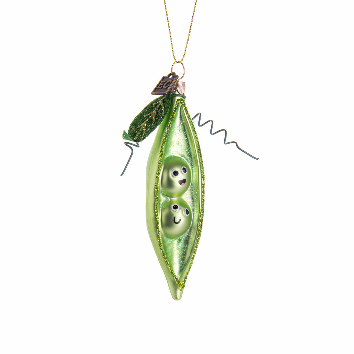 Green glass ornament shaped like a pod with two peas inside on a white background