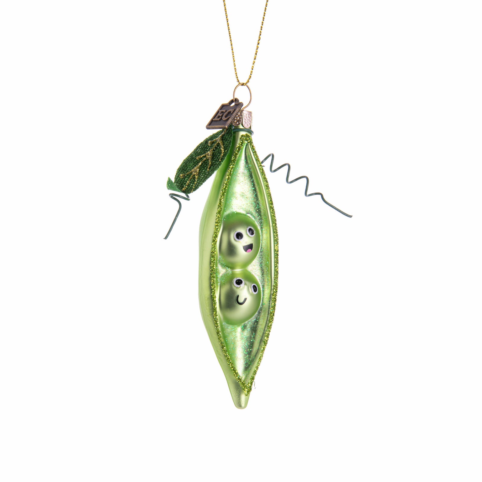 Green glass ornament shaped like a pod with two peas inside on a white background