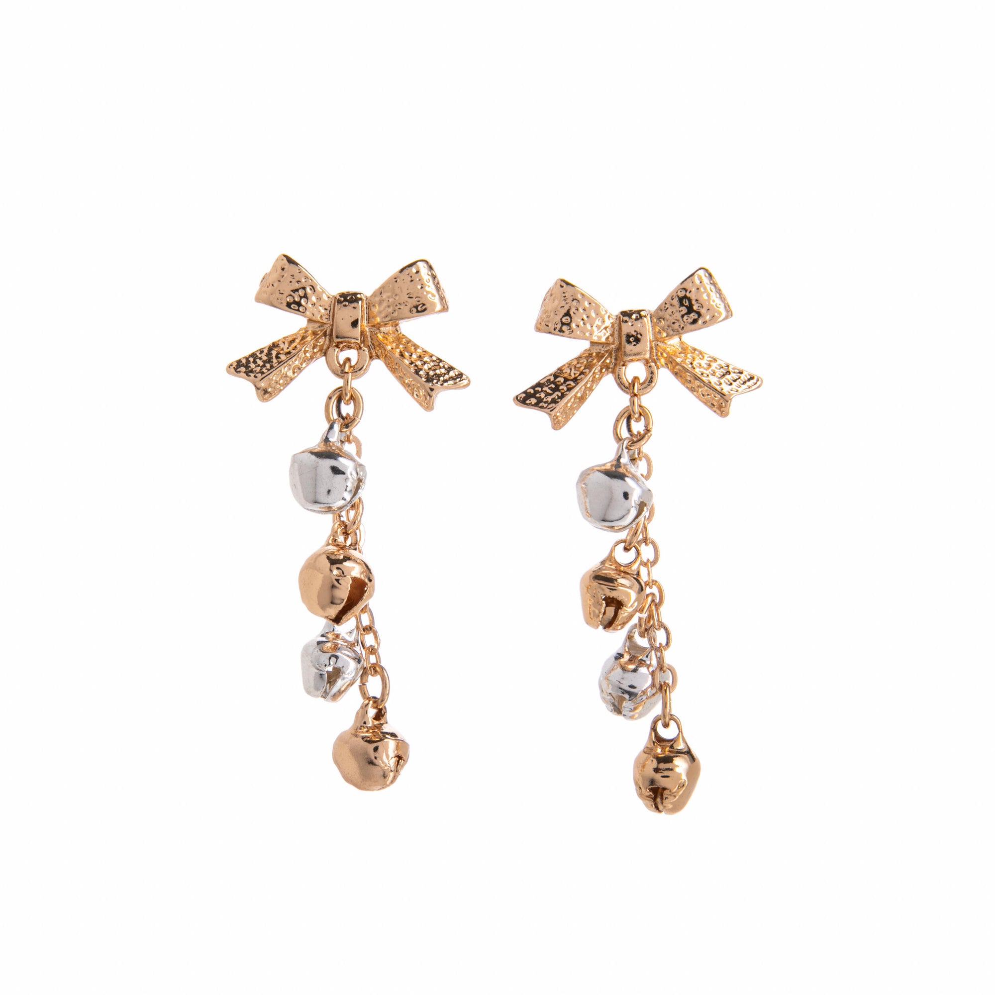 Gold bow-shaped earrings with gold and silver bell charms on a white background
