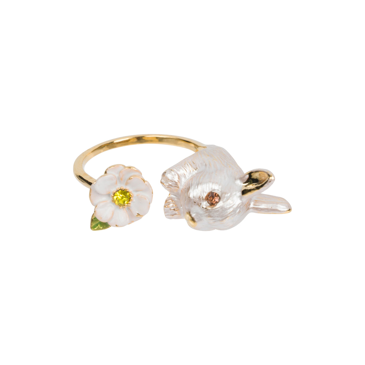 A gold ring featuring a white enamel flower with a yellow center and a white rabbit head with gold accents, set against a plain white background.