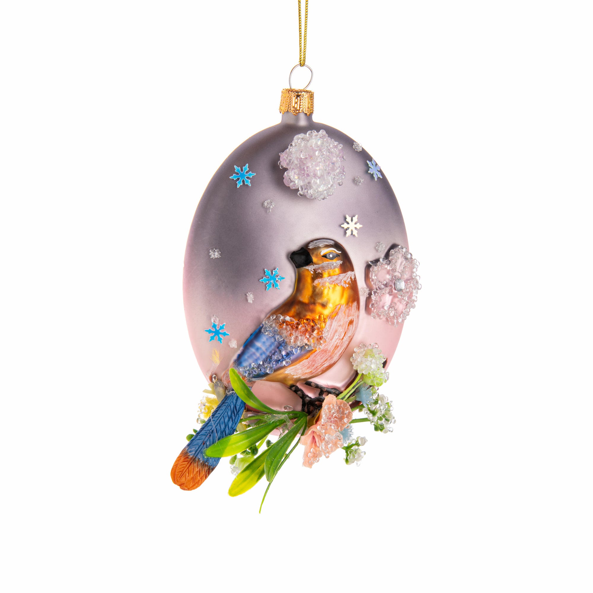 Glass ornament with a bird perched on a branch on a lilac ball with snowflakes on a white background.