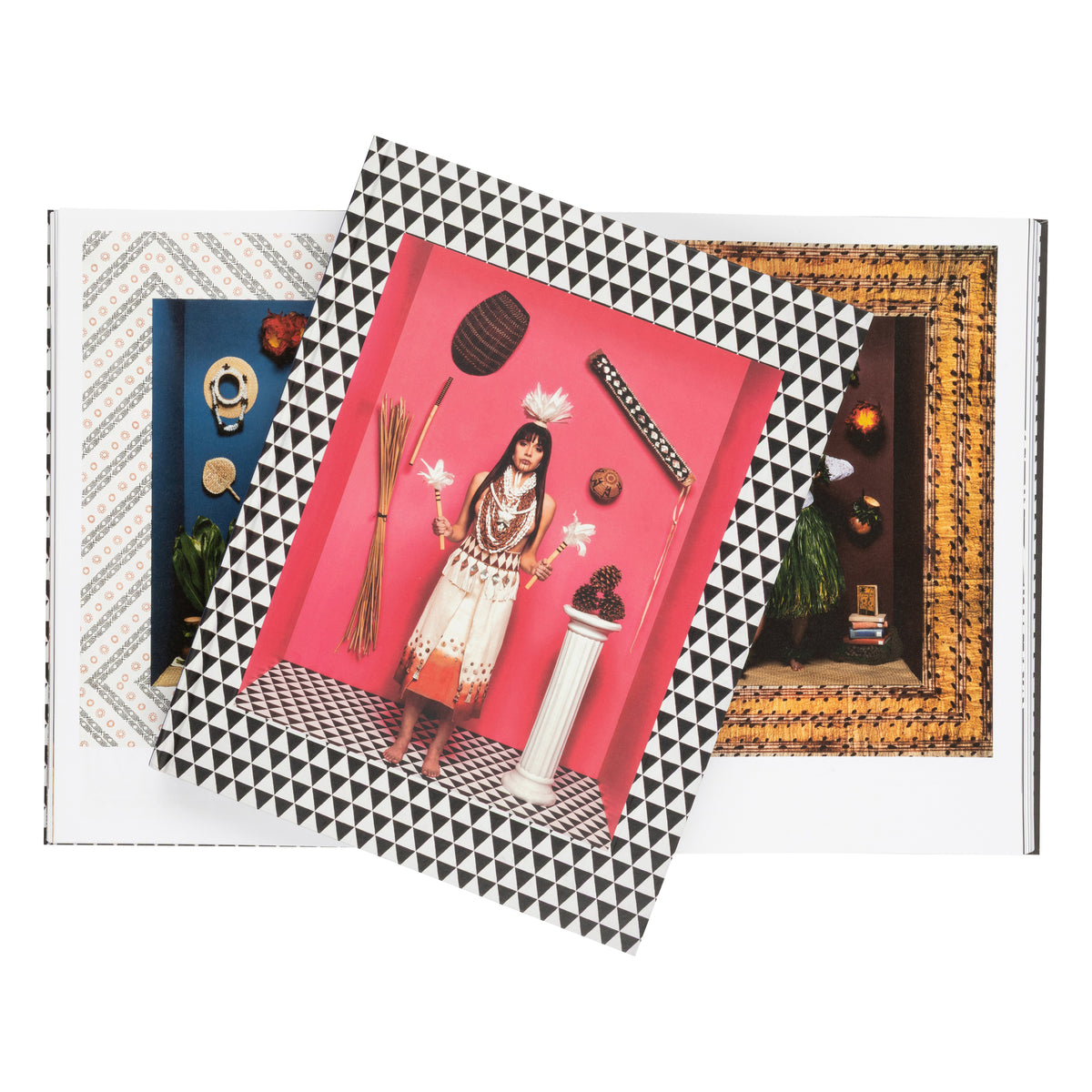 Book on the photography of Cara Romero with a geometric black and white pattern on the cover, featuring a pink interior with decorative items.