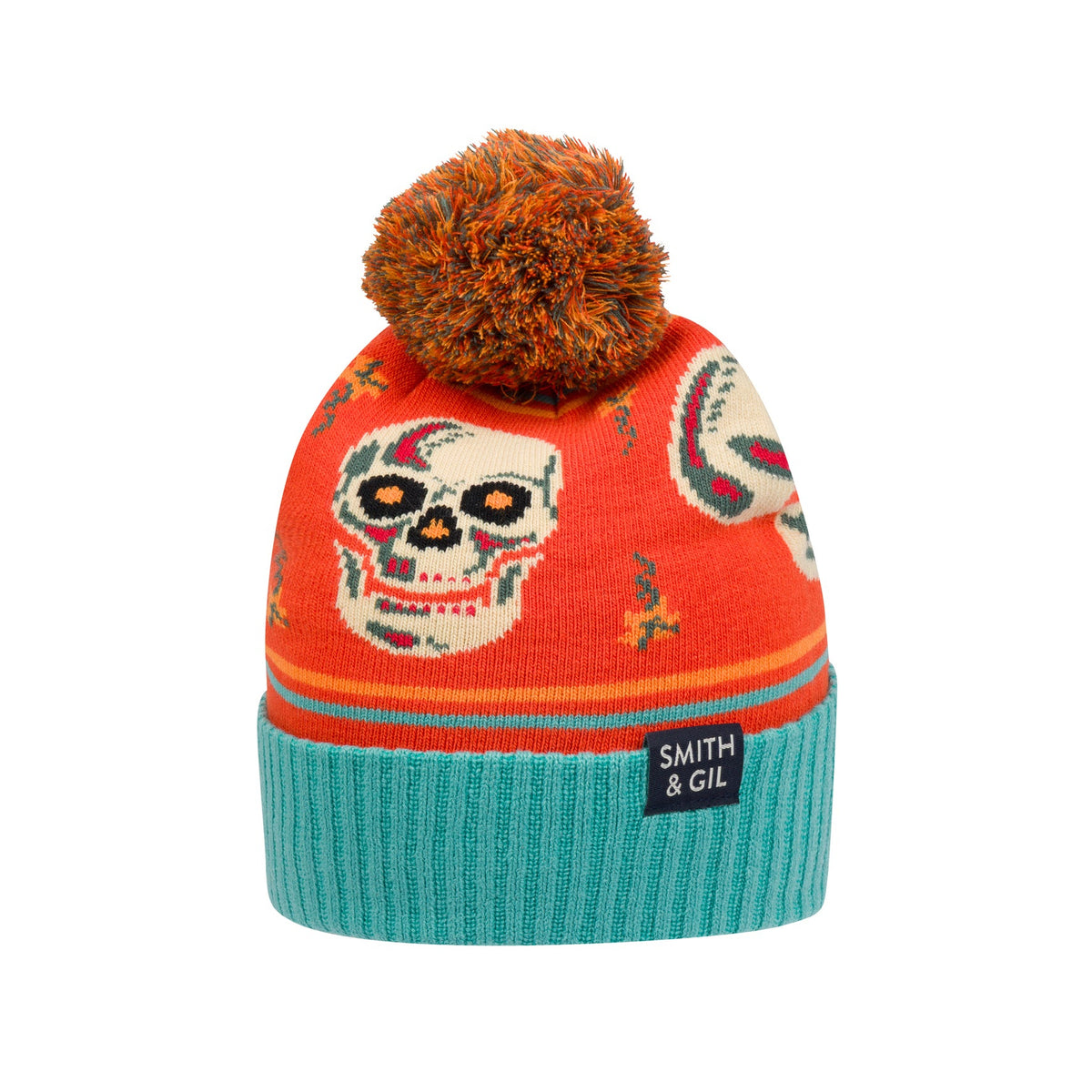 Colorful knit beanie with skull design and orange pom-pom on a white background
