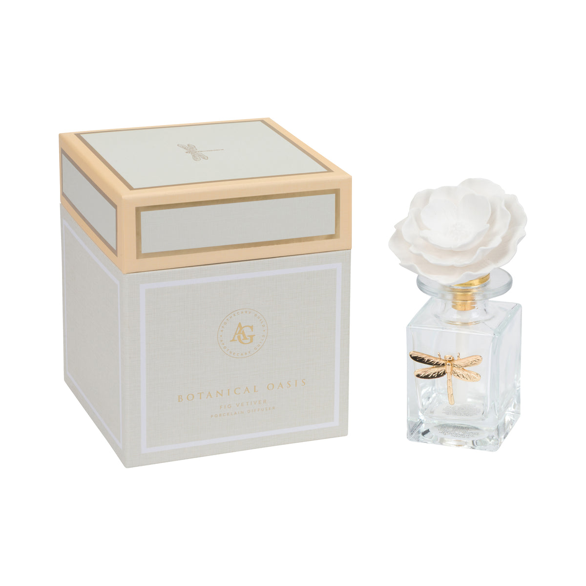 A clear glass fragrance diffuser bottle with a white rose-shaped stopper and a gold dragonfly decoration, shown next to its matching cream and gold box on a white background.