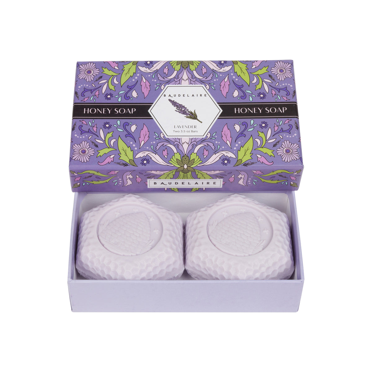 A lavender honey soap gift set by Baudelaire, featuring two round white textured soap bars in a light lavender box with a floral-patterned lid.