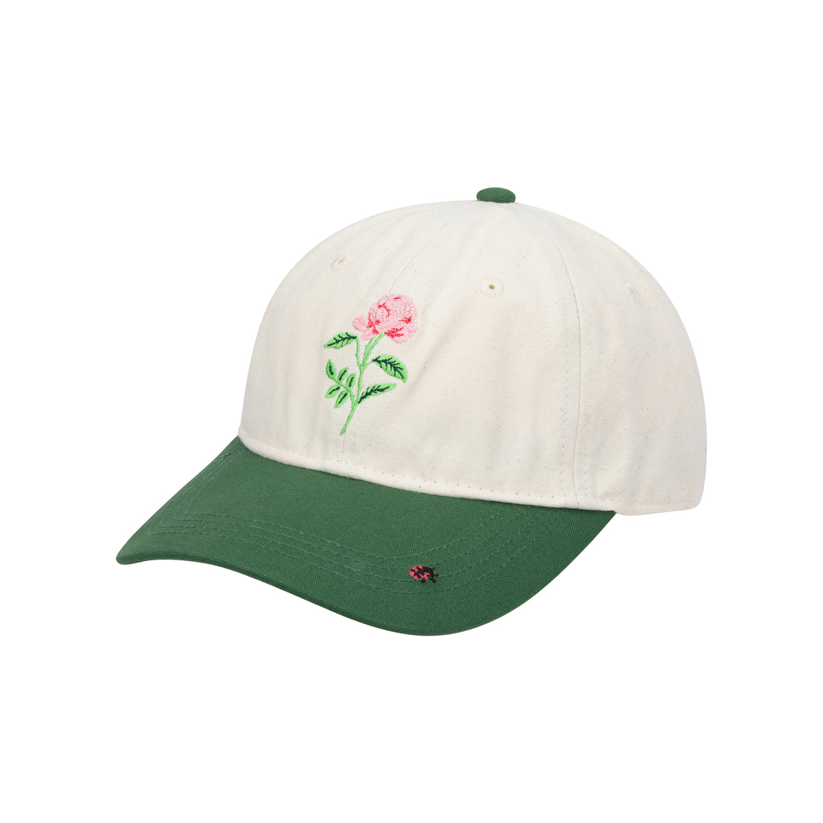 Baseball cap with a cream crown featuring an embroidered pink rose, and a green bill with a small embroidered ladybug on a white background. 