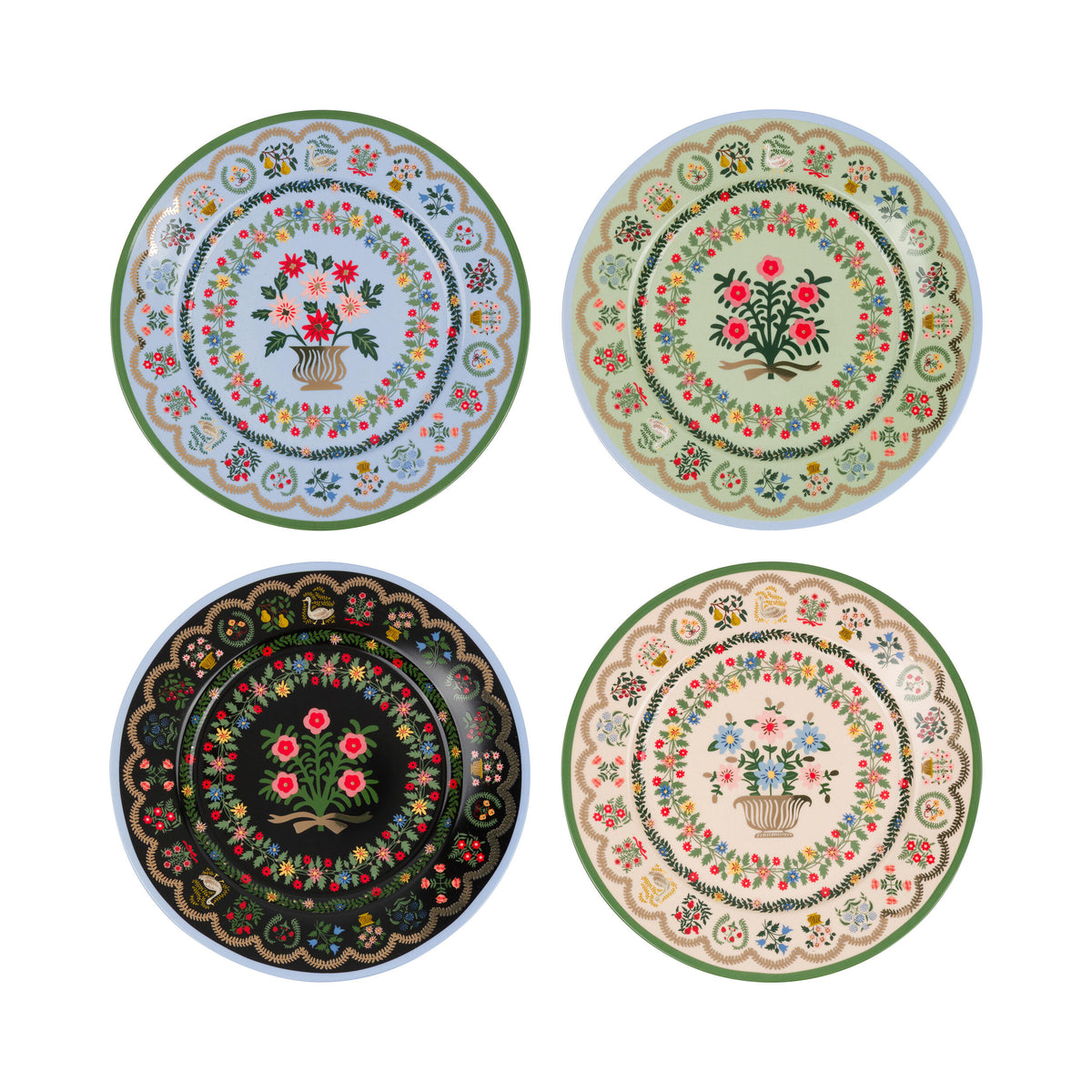 Four decorative plates with floral and geometric patterns on a white background