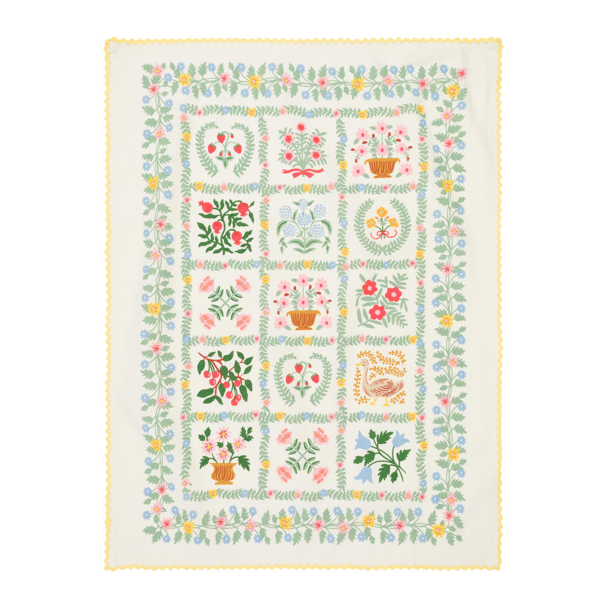Quilt with floral and geometric patterns on a white background