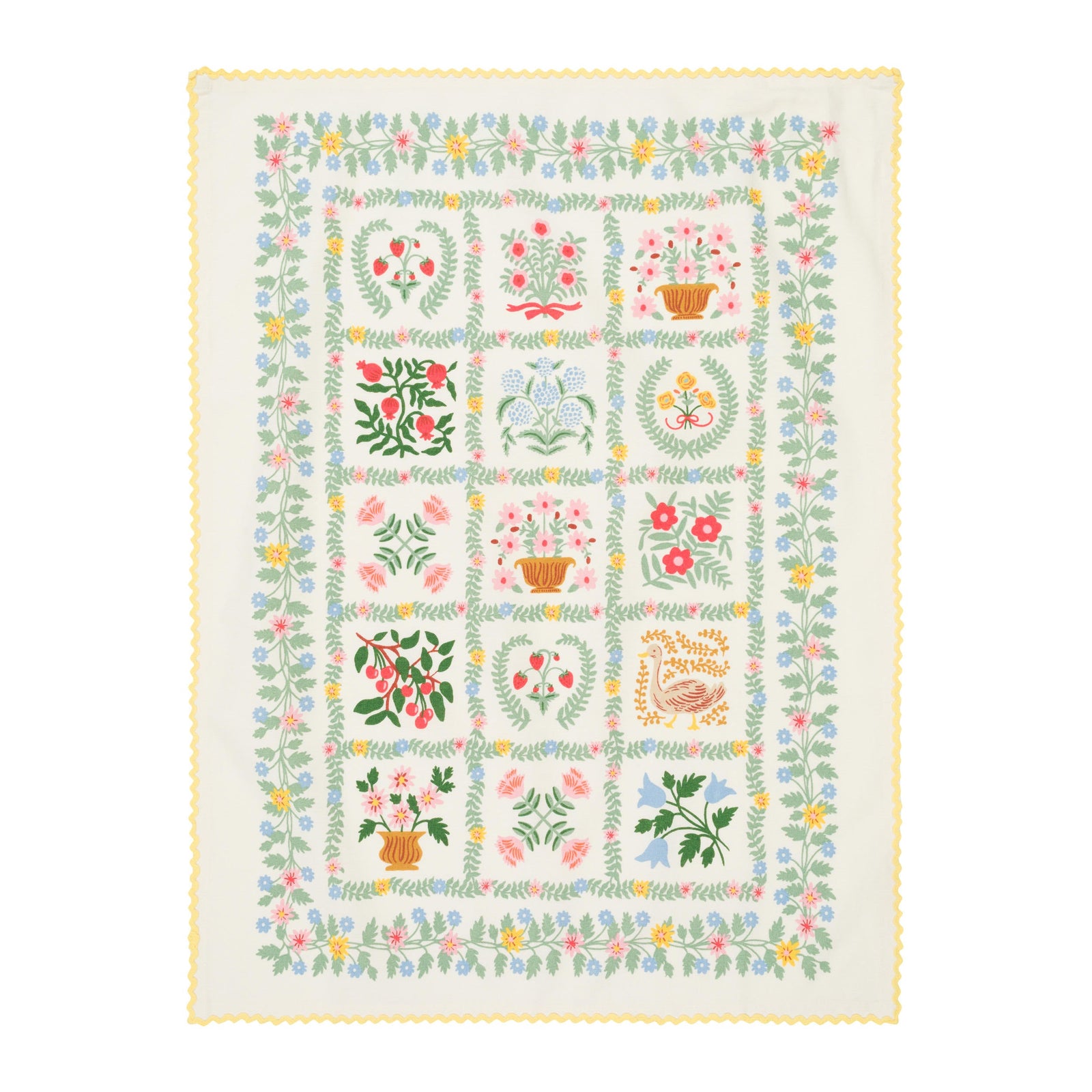 Quilt with floral and geometric patterns on a white background