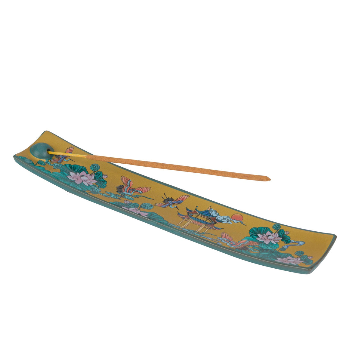 A decorative incense holder with a long wooden stick resting across it, featuring a yellow and teal floral design with birds and lotus motifs on a plain white background.