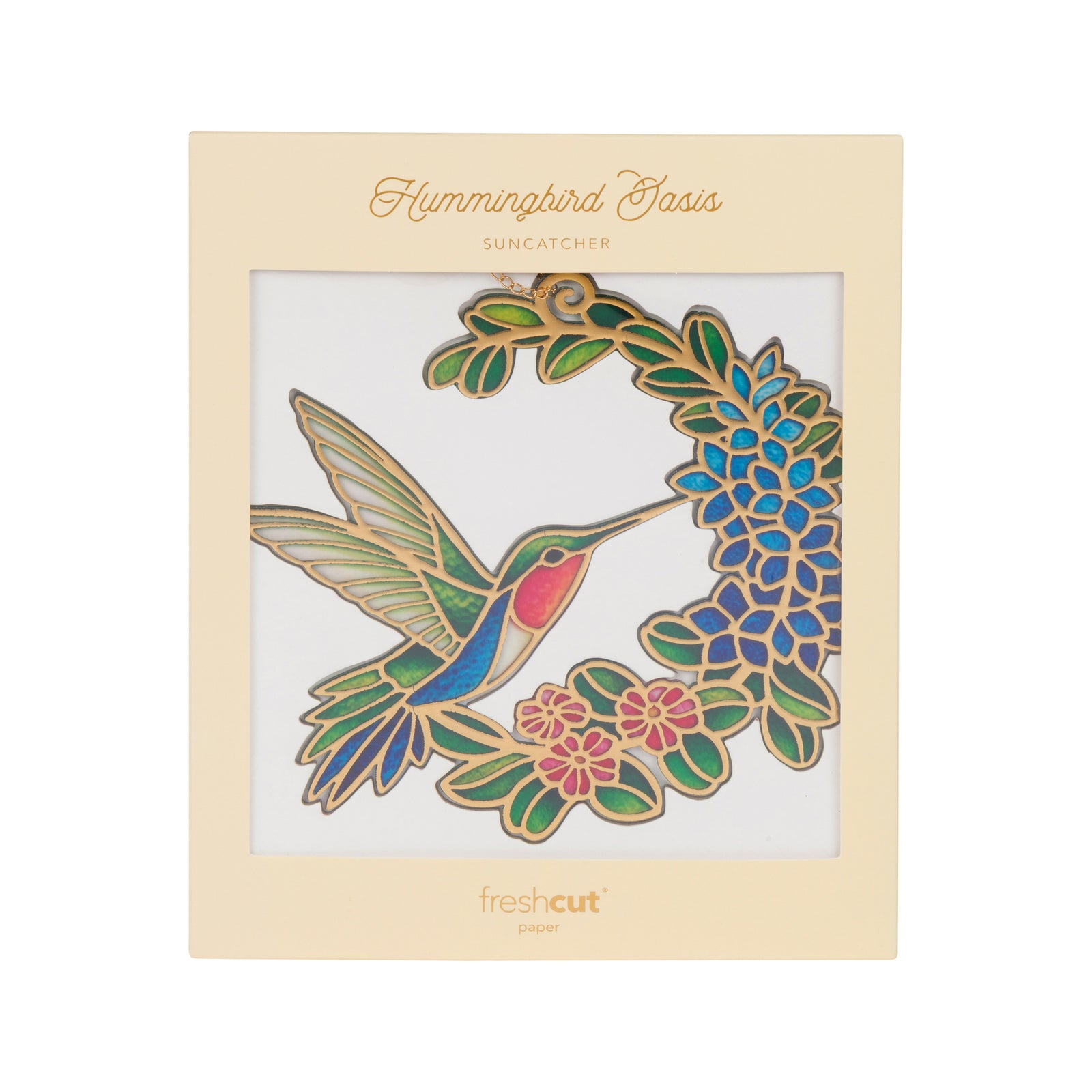 A stained glass hanging ornament featuring a hummingbird in flight beside a crescent-shaped arrangement of blue flowers, green leaves, and pink blossoms, suspended by a gold chain on a white background.