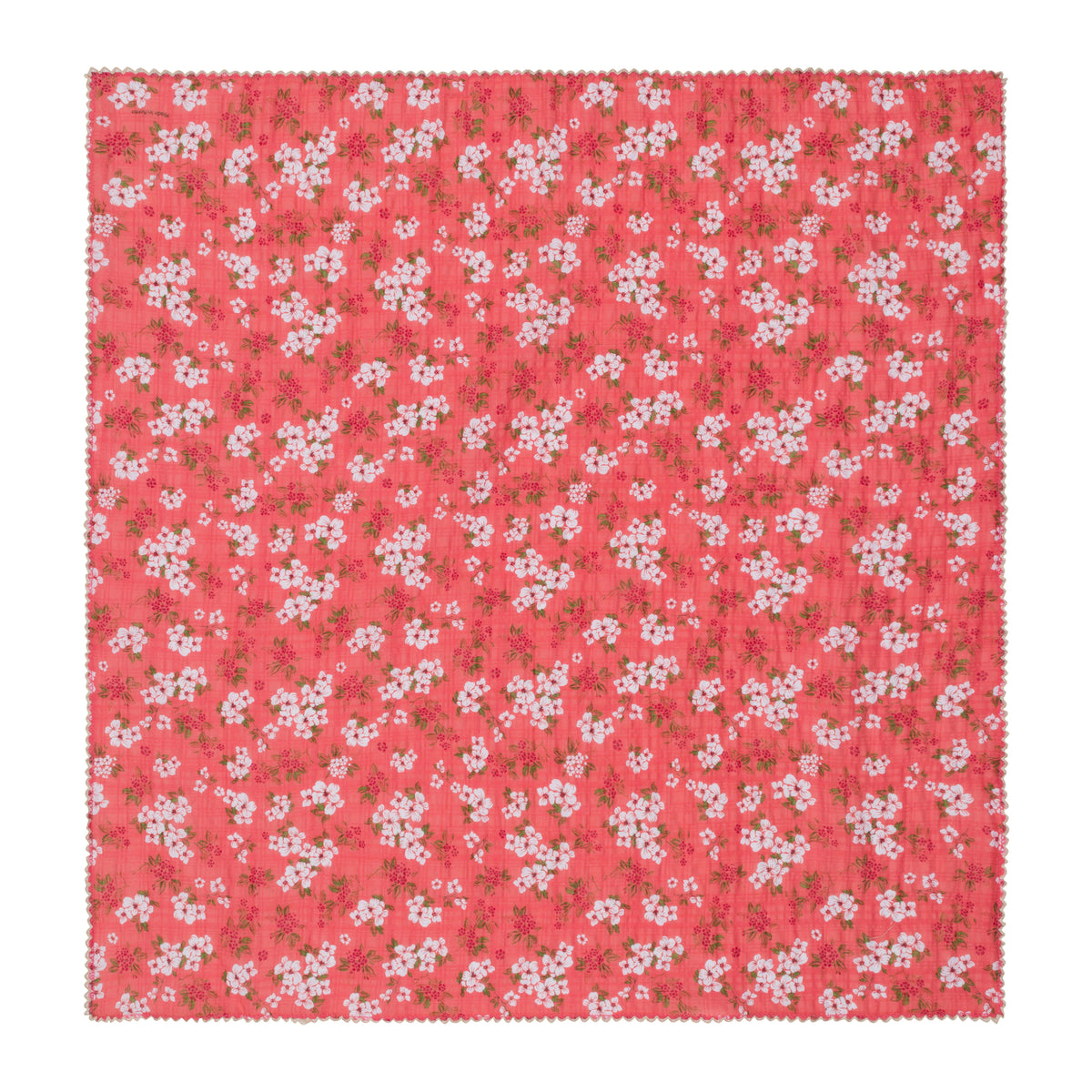 A square cotton bandana with a coral pink background and an all-over white cherry blossom floral pattern, finished with a scalloped edge.