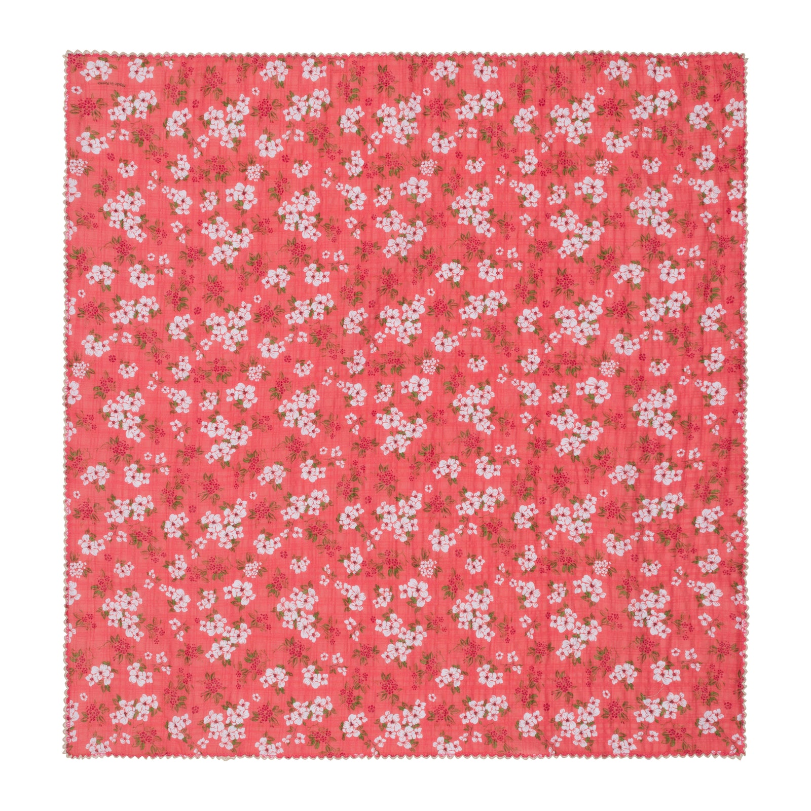 A square cotton bandana with a coral pink background and an all-over white cherry blossom floral pattern, finished with a scalloped edge.