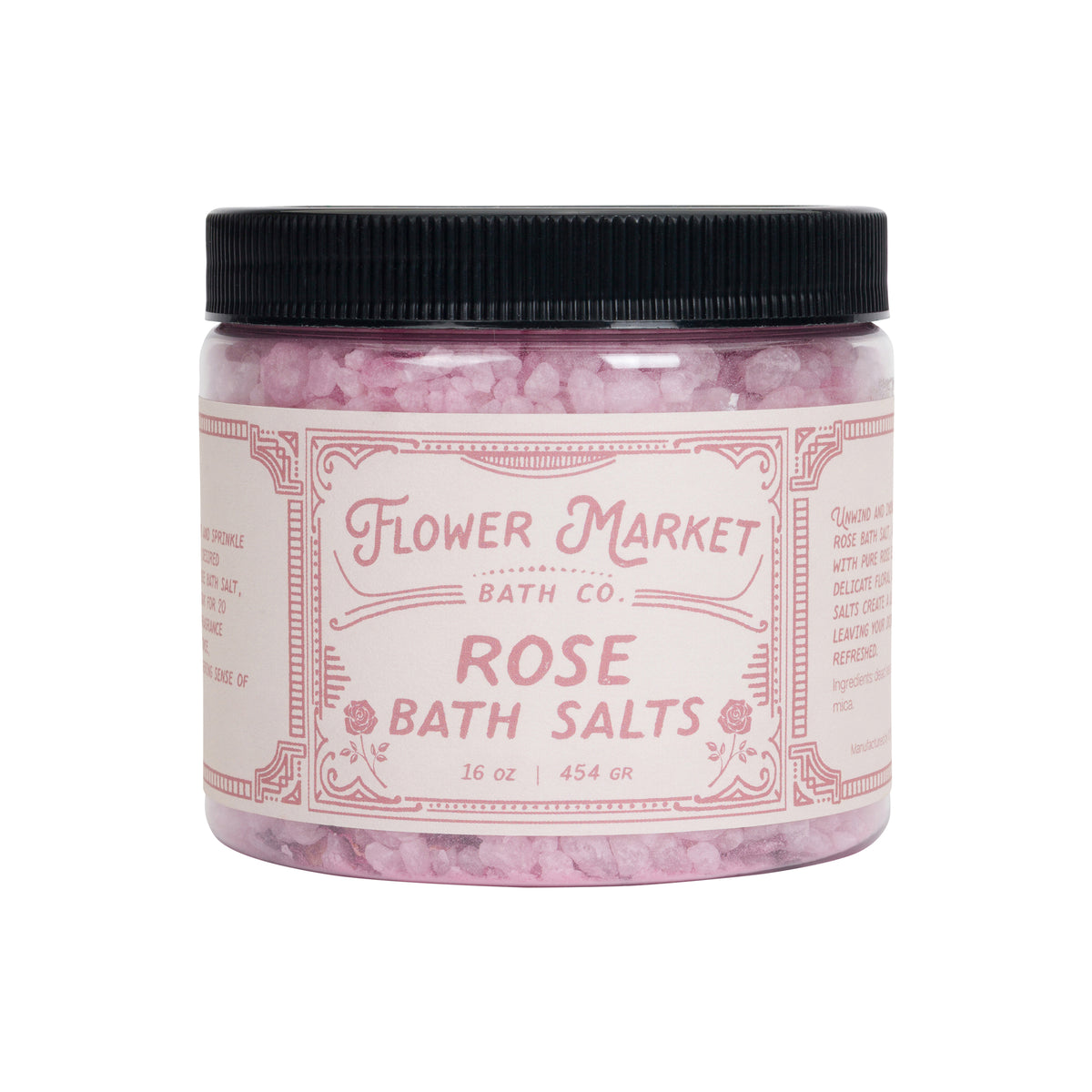 Jar of rose scented pink bath salts on a white background.