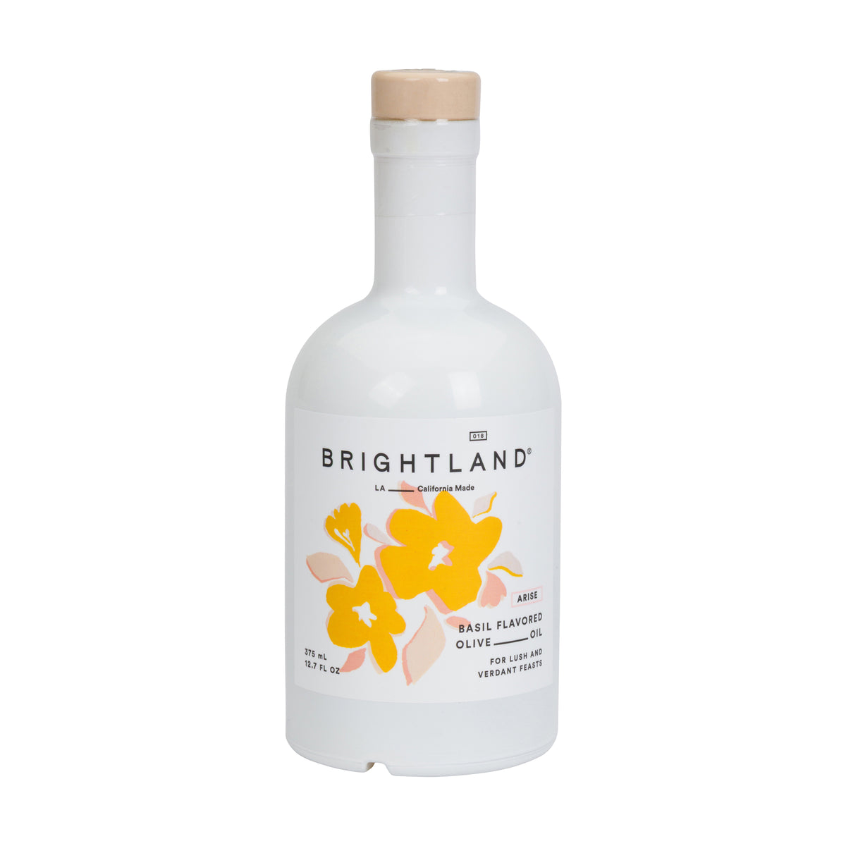Brightland Basil Flavored Olive Oil in a white glass bottle with a light wood cap and a label featuring yellow and orange flowers.
