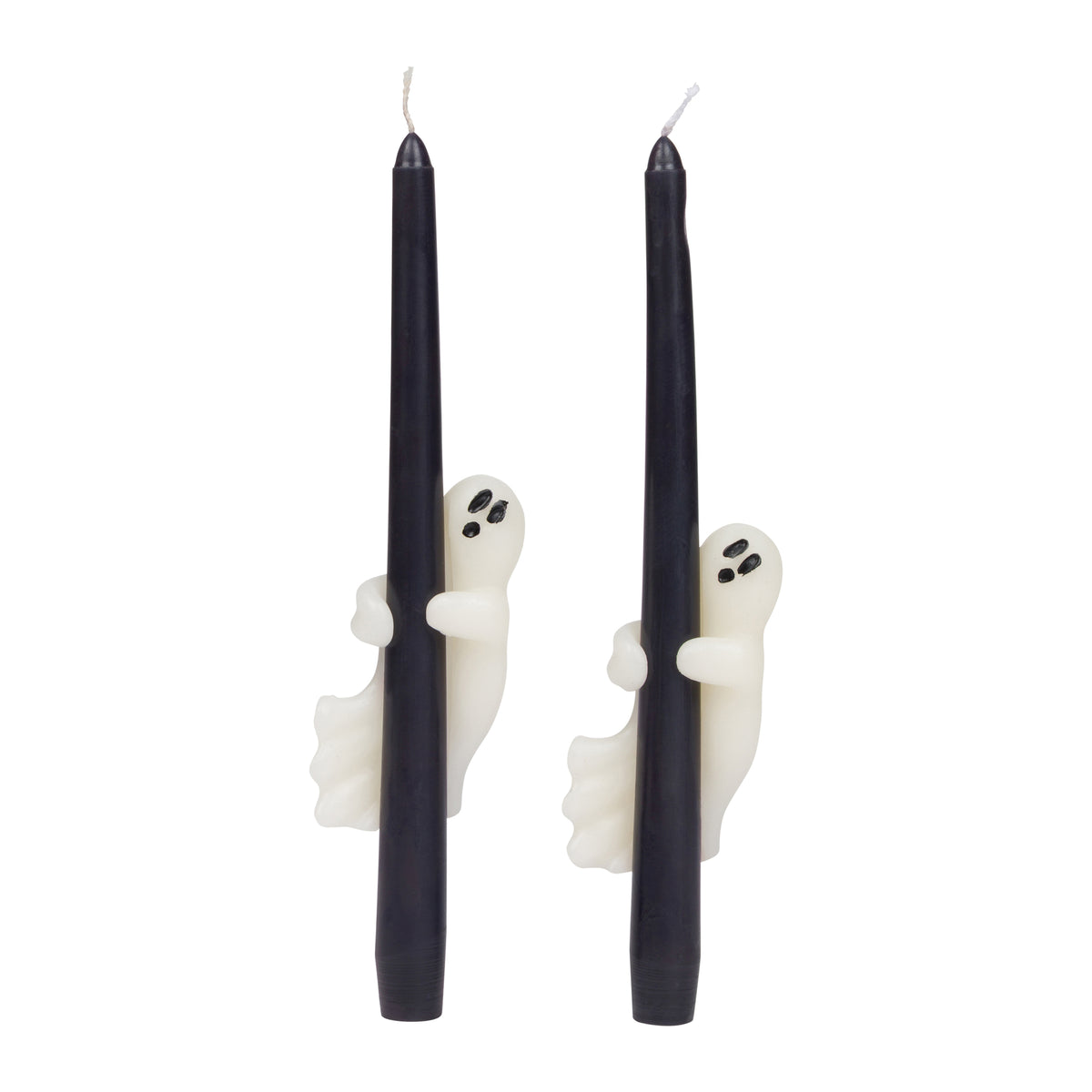 Two black taper candles with a little white wax ghost clinging onto the candle, shown on a plain white background.