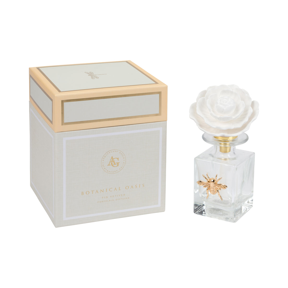 A clear glass diffuser bottle with a white rose-shaped cap and gold bee detail, shown next to its white and gold Botanical Oasis fragrance box on a white background.