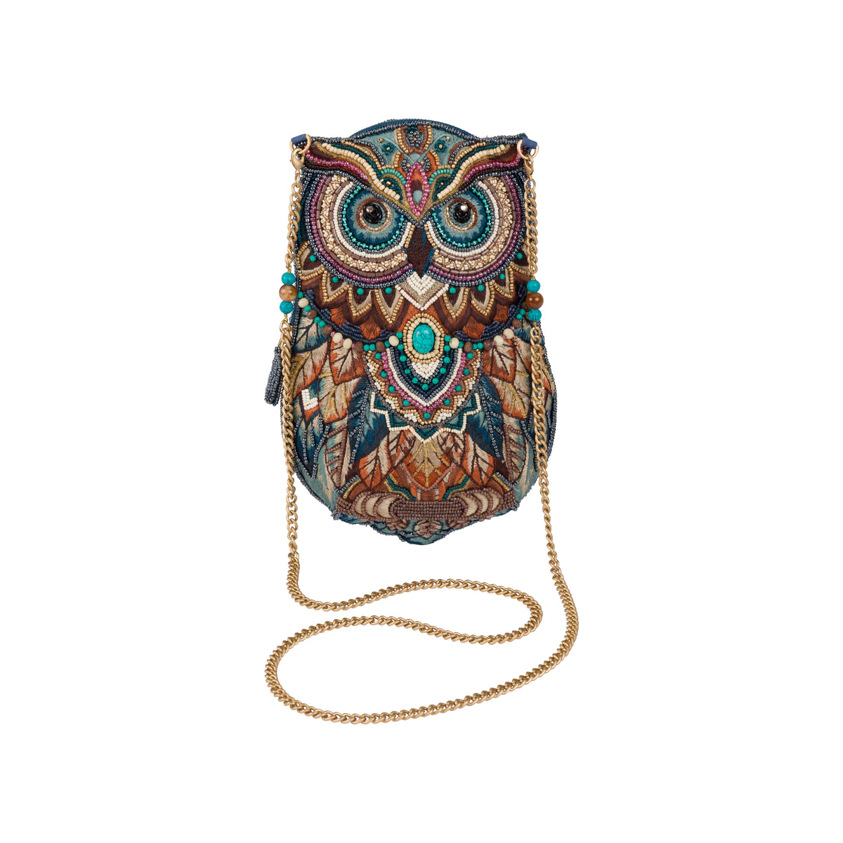 An owl-shaped crossbody bag with an intricate, colorful embroidered pattern in shades of blue, brown, gold, and teal, featuring a gold chain strap, set against a plain white background.