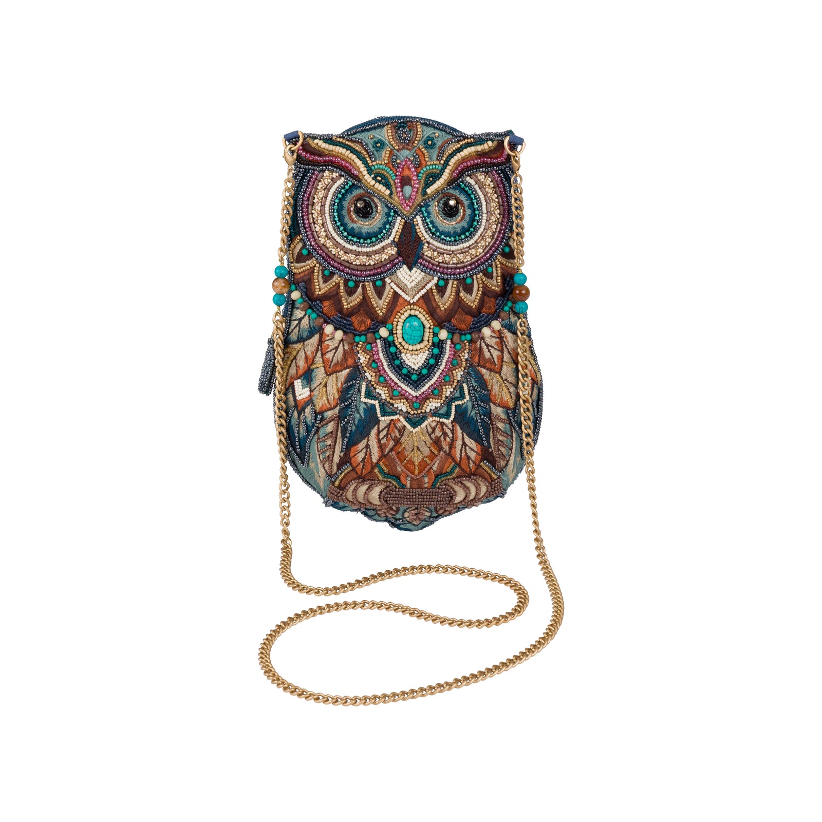 An owl-shaped crossbody bag with an intricate, colorful embroidered pattern in shades of blue, brown, gold, and teal, featuring a gold chain strap, set against a plain white background.