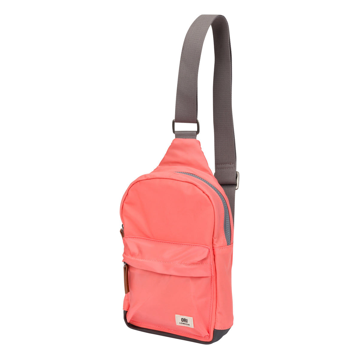 A coral pink sling backpack with a gray adjustable shoulder strap, shown on a solid white background.