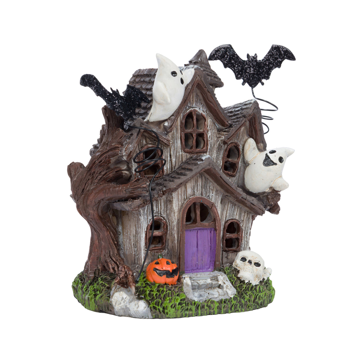 Halloween haunted house figurine with white ghosts, black bats, a purple door, and a jack-o'-lantern on a green grassy base.