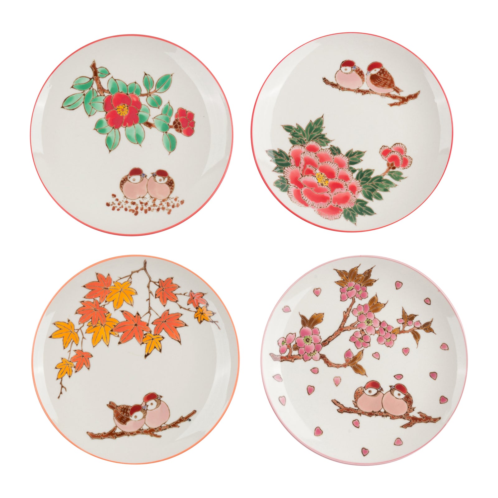 Four round ceramic plates arranged in a 2x2 grid on a white background, each decorated with hand-painted floral and bird motifs including red flowers, green leaves, pink blossoms, and small birds on branches.
