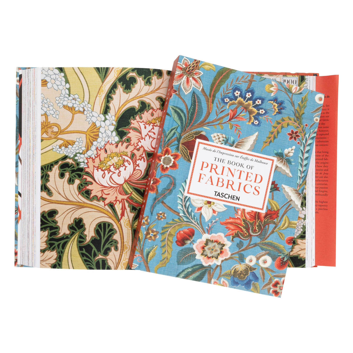 The Book of Printed Fabrics by Taschen, showing a book cover with a blue floral pattern in the foreground and a beige floral patterned fabric sheet in the background.