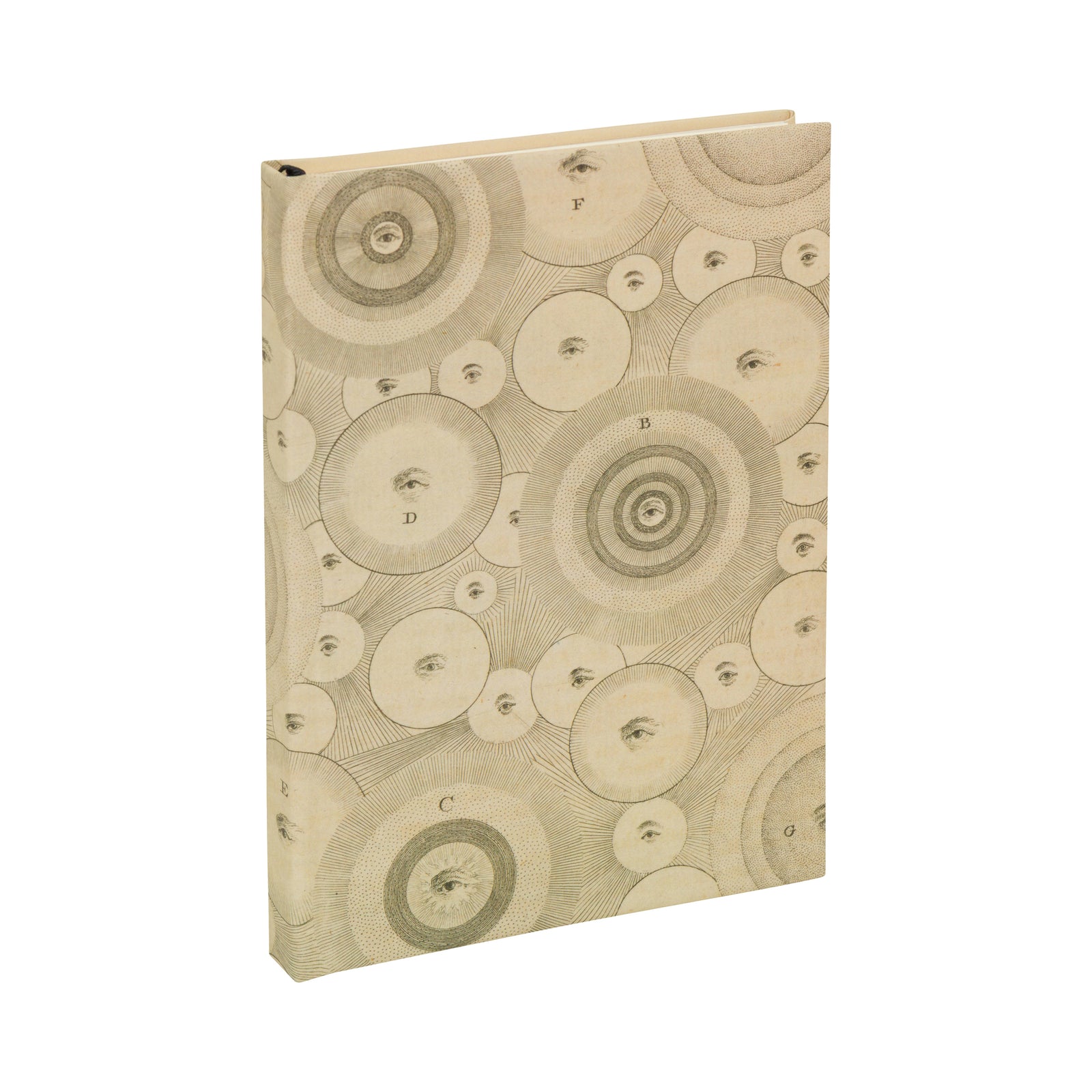 A hardcover, lined paper journal with an 18th century illustration on a cream base featuring planets and eyes.