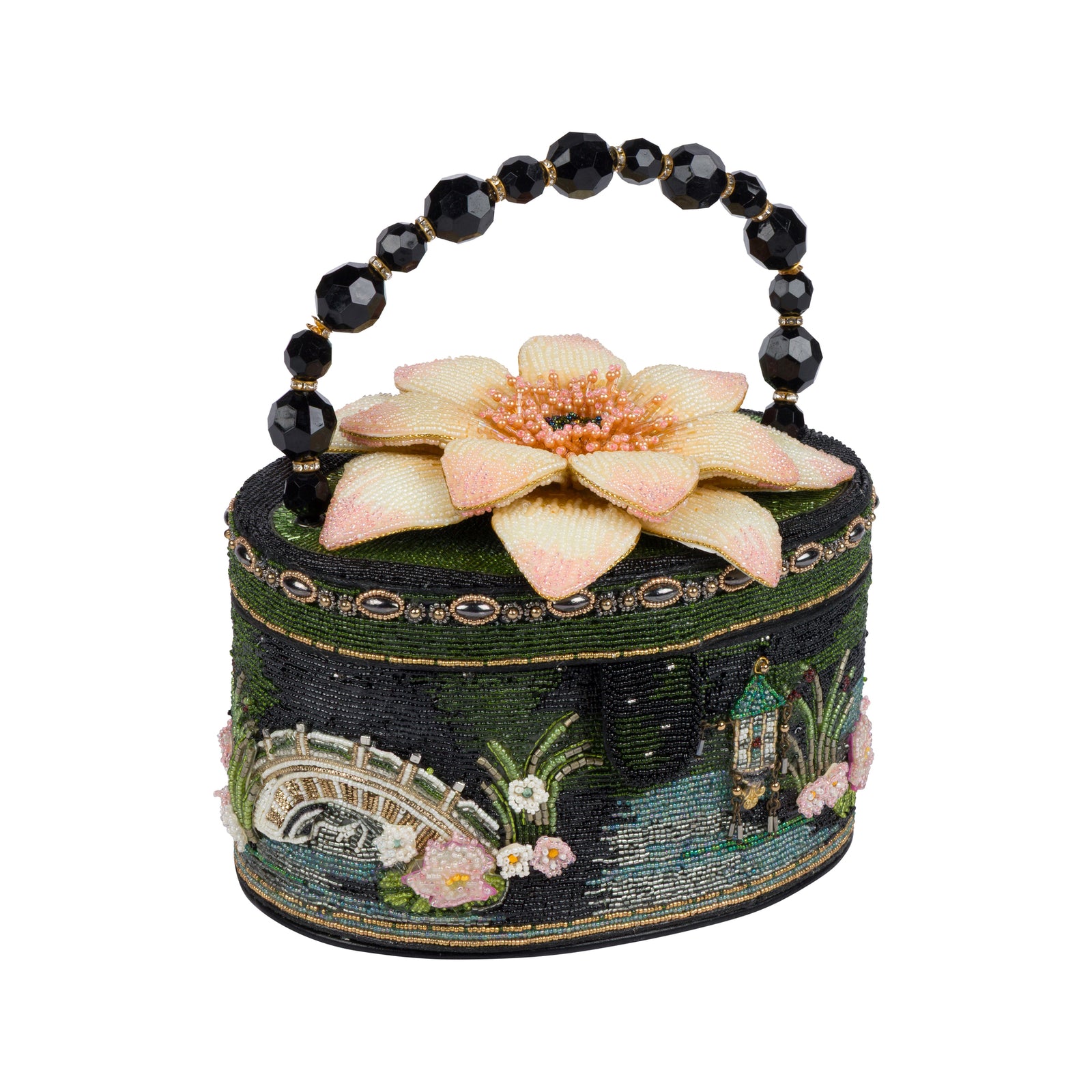 A small round handbag with a beaded black handle, featuring a dark green embroidered Japanese garden landscape design with a pink lotus flower on top, set against a plain white background.