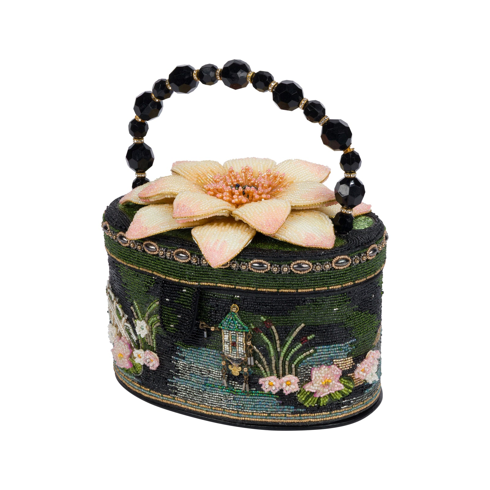 A small round handbag with a beaded black handle, featuring a dark green embroidered Japanese garden landscape design with a pink lotus flower on top, set against a plain white background.