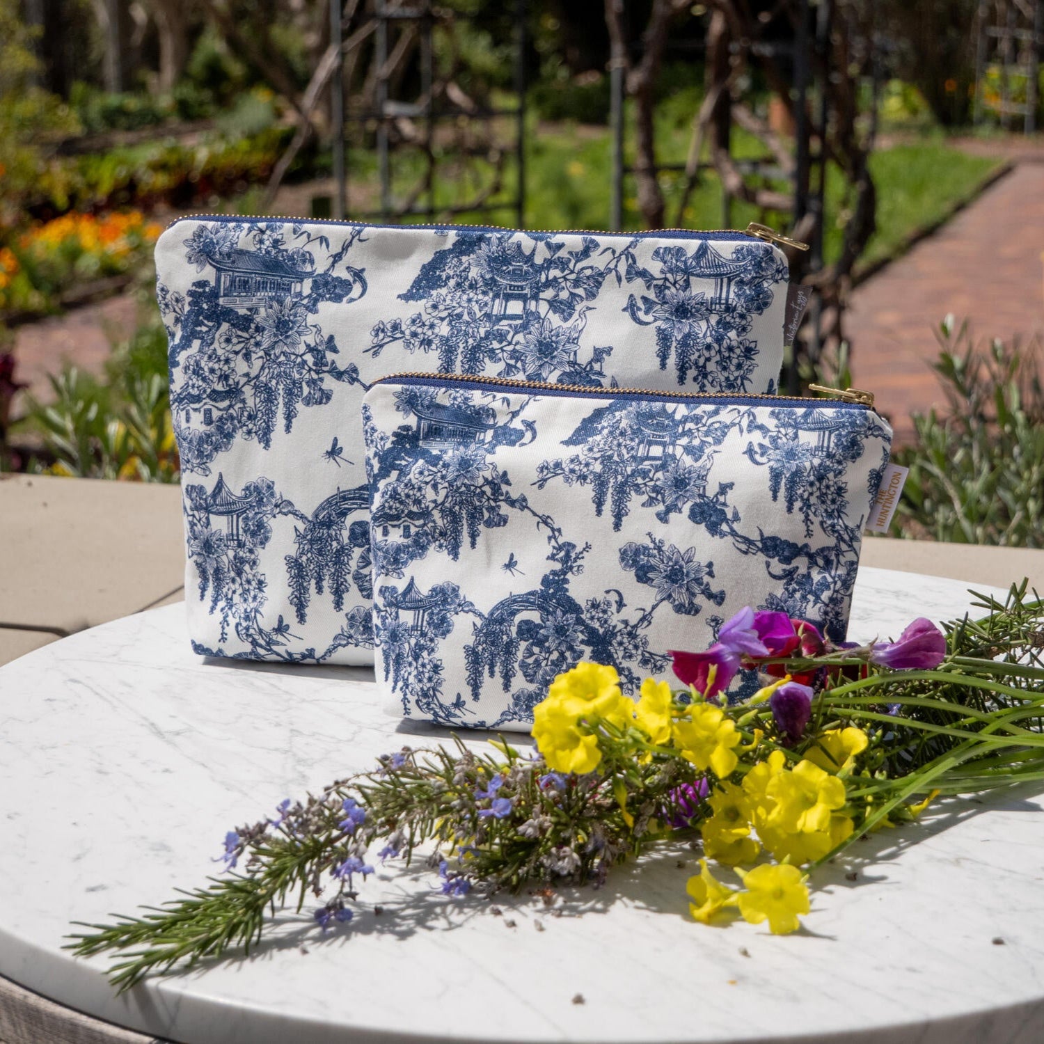 This pretty and practical wash bag features our exclusive Asian Gardens toile print. 100% cotton outer. Gold zipper closure Dimensions: 12" x 8" x 2" 