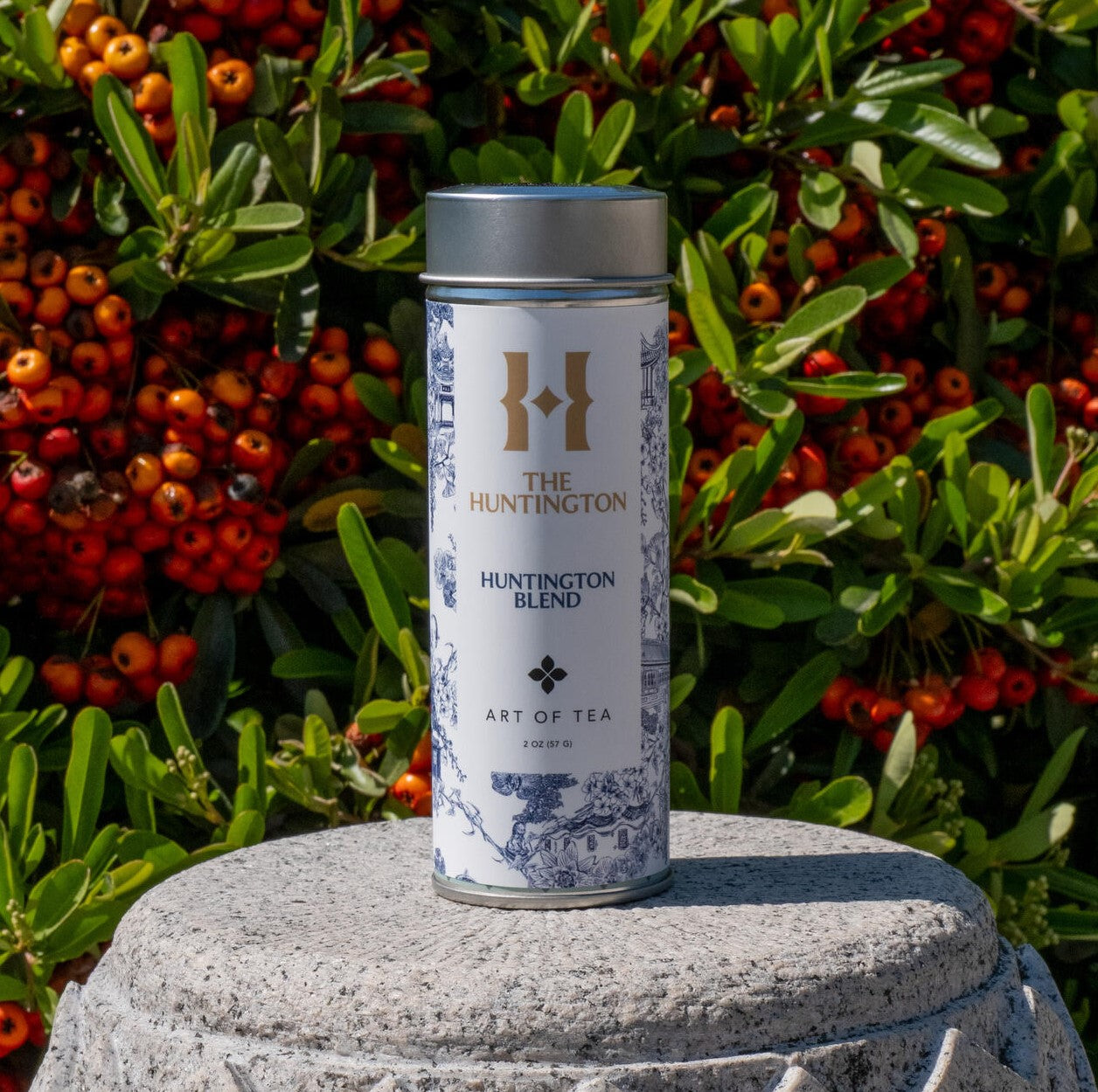 A canister of Huntington Blend tea with a label featuring a classic toile pattern.