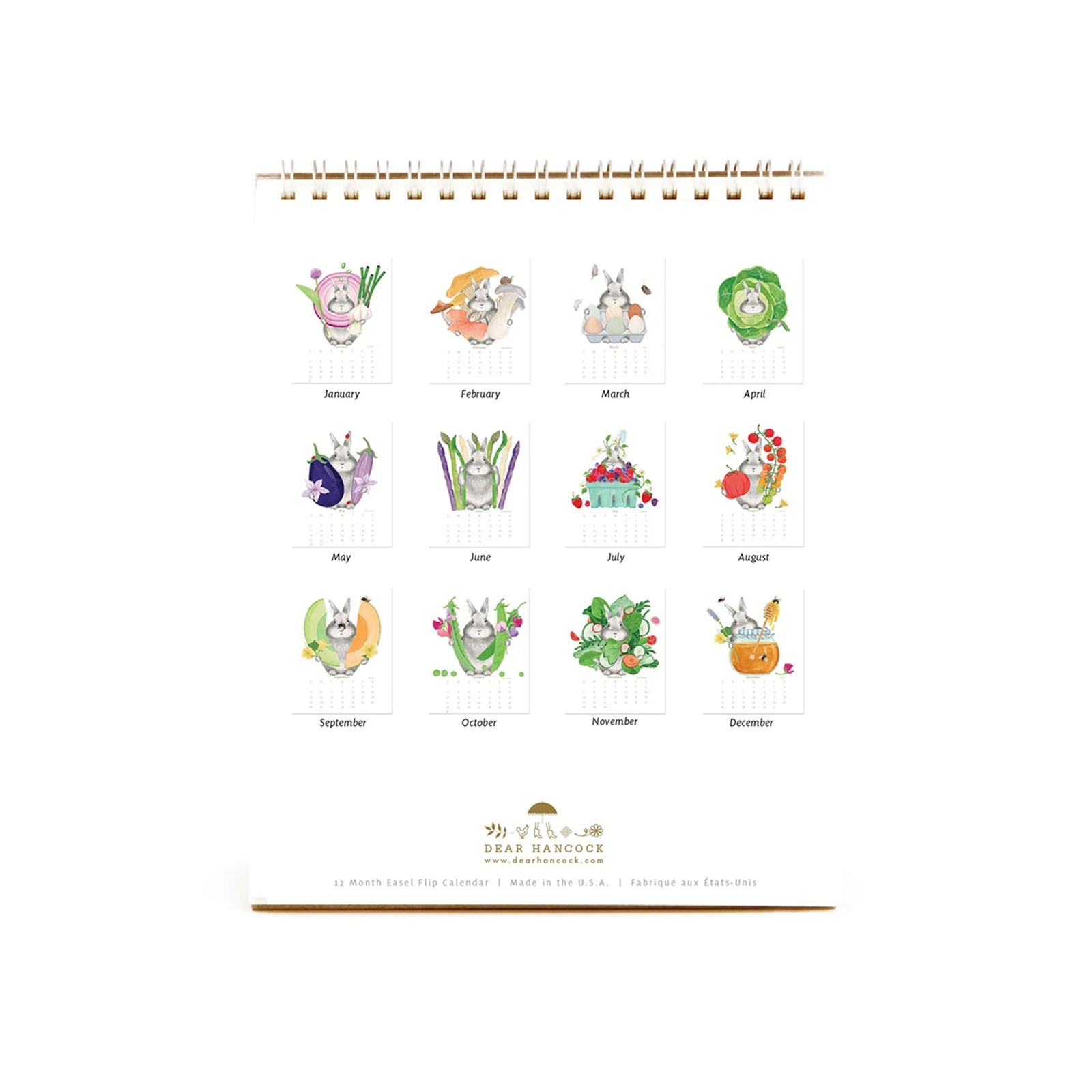 The Bunny Calendar 2027 featuring a watercolor illustration of a gray bunny surrounded by green peas and pink and purple flowers, on a white background with a gold spiral binding.