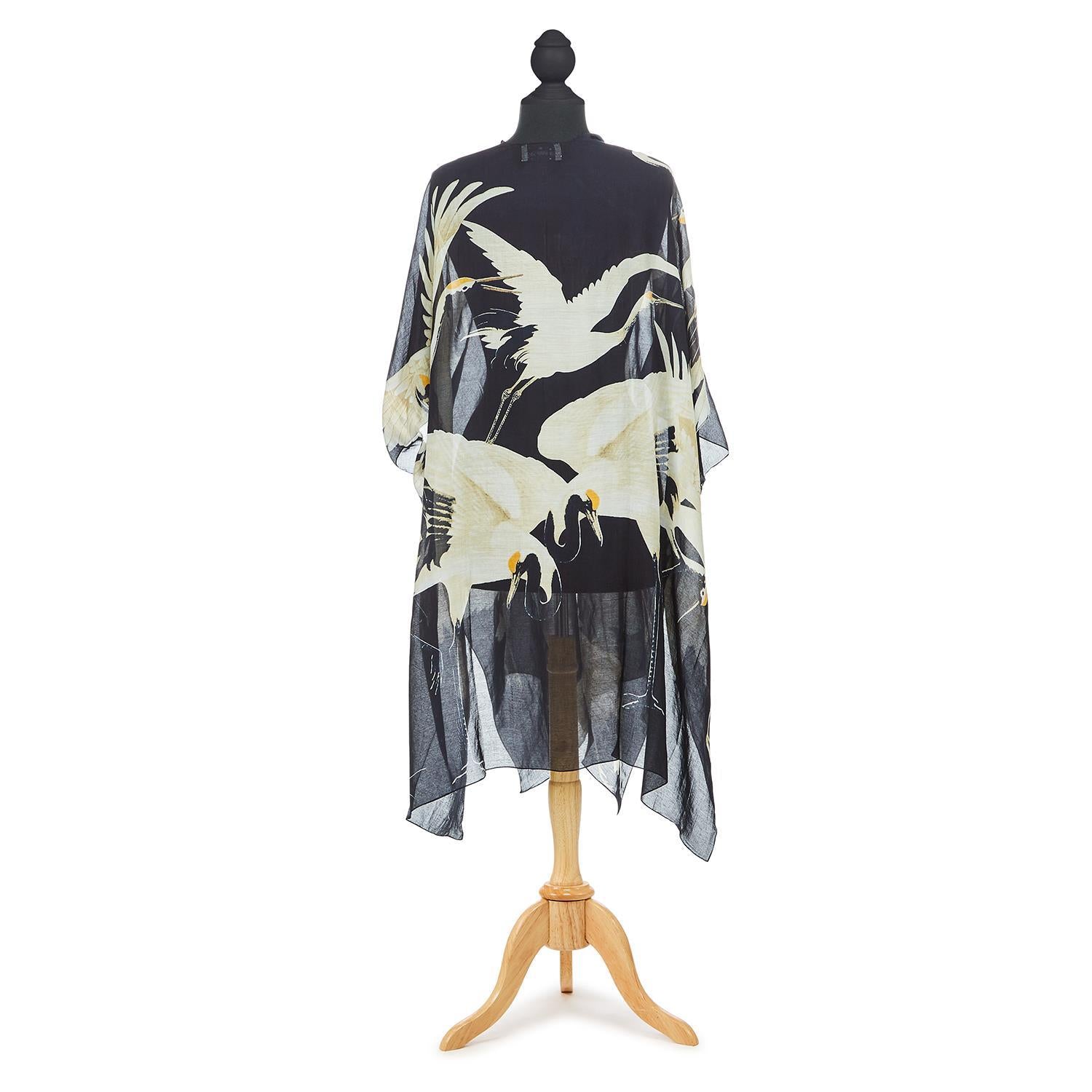 The perfect summer cover up, in a vintage Japanese style Heron print. This long, cardigan style kimono has a beautifully gauzy feel and is lightweight enough to fold up and pop in your purse, but also heavy enough to keep the chill off when the sun goes down. 50% Modal and 50% Viscose One size.  Measures 41" W x 44".