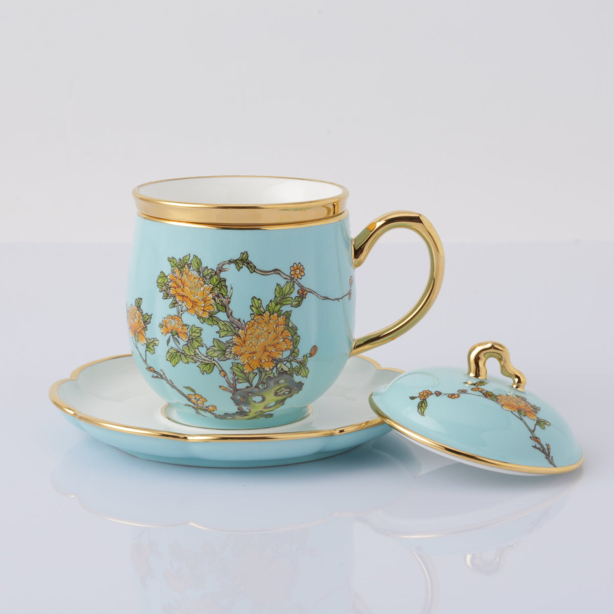 Inspired by the beautiful landscape of the West Lake in Hangzhou, China, this stunning four-piece teacup set is made from highly refined, premium, chip-resistant porcelain and is decorated with traditional Peony blooms on a glossy azure-blue base, accented with luxurious gold metallic. This set contains a lidded teacup, petal-shaped saucer, and porcelain tea strainer