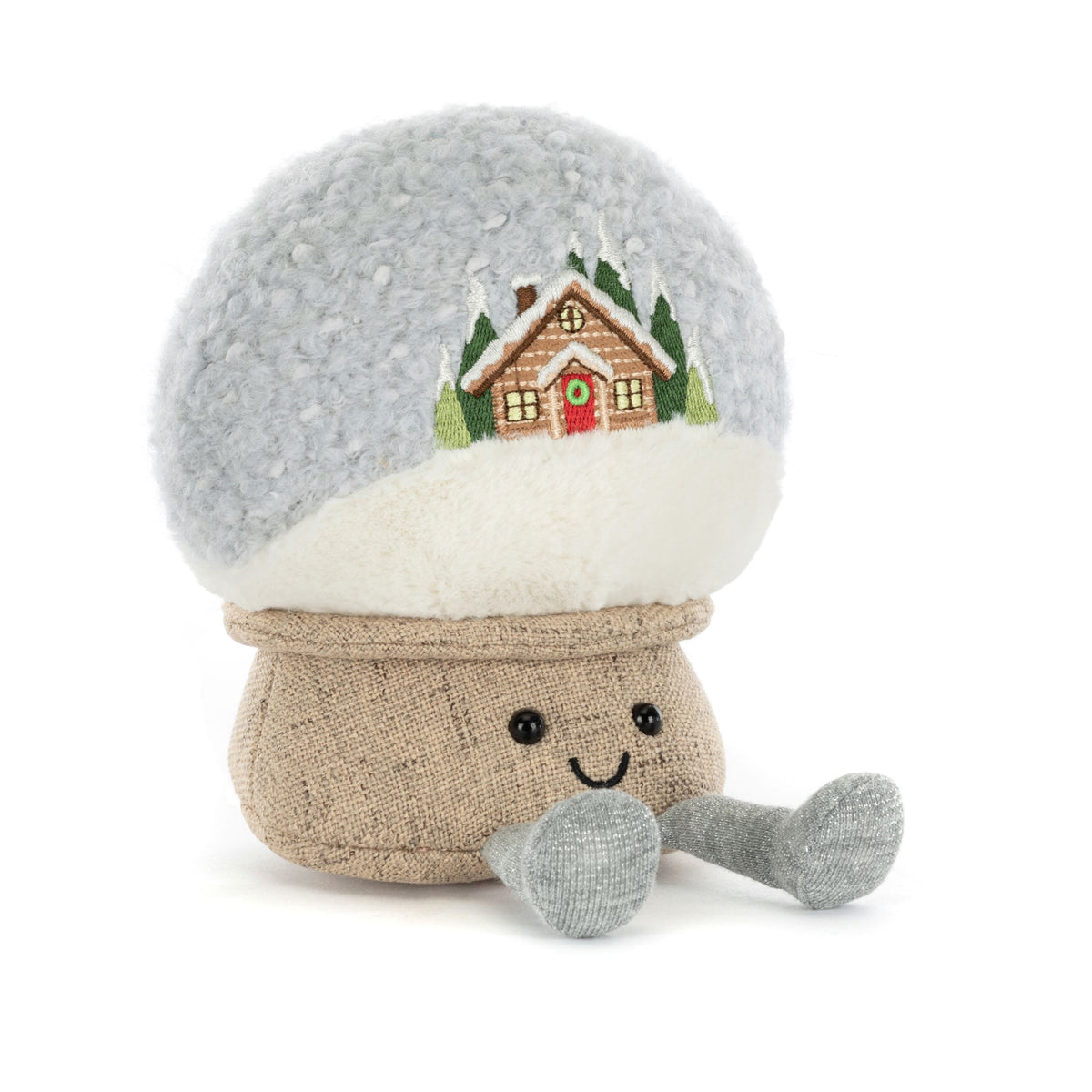 Stuffed Jellycat toy with a snow globe design featuring a house on a white background
