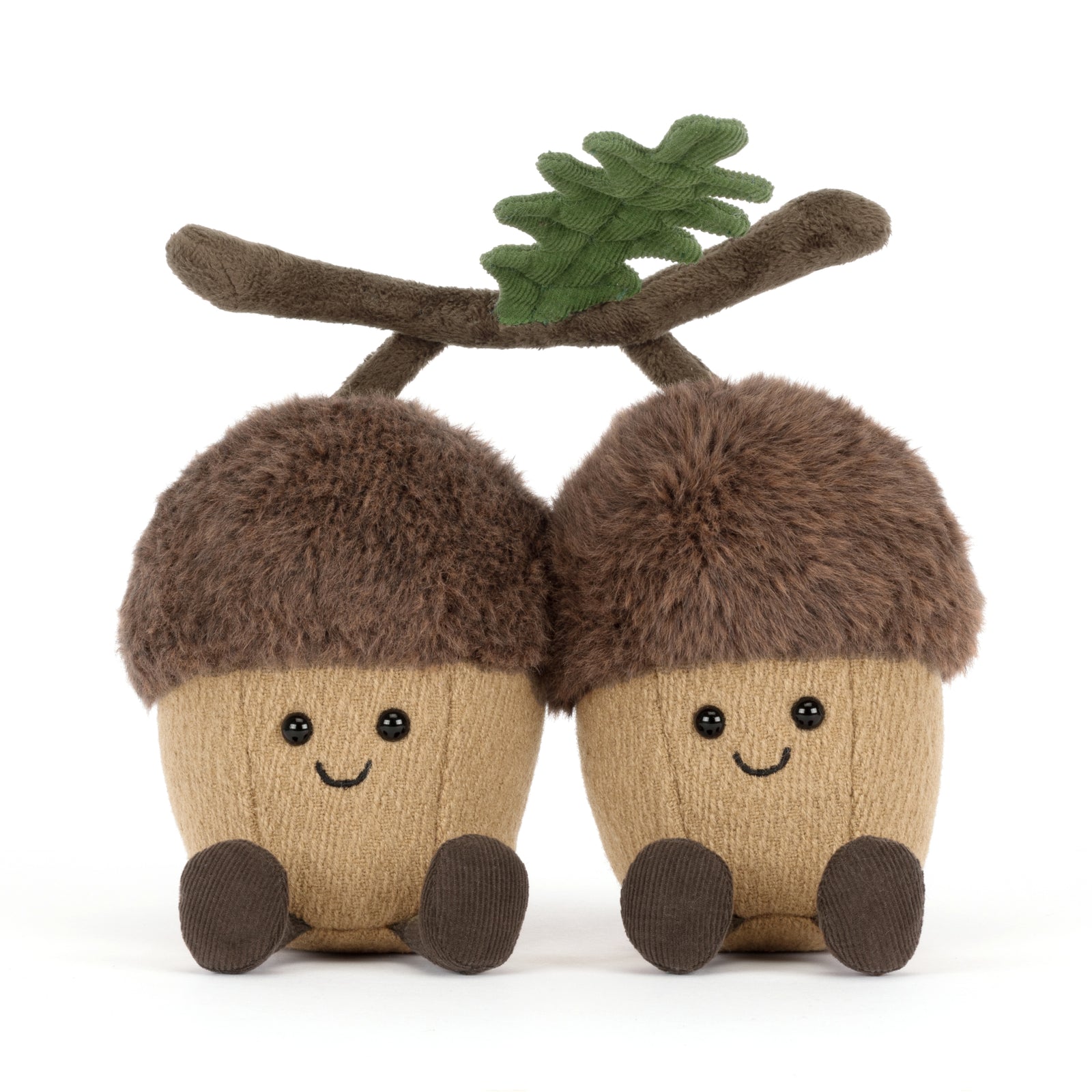 Two plush Jellycat Ort & Tum acorns with faces and a branch on a white background