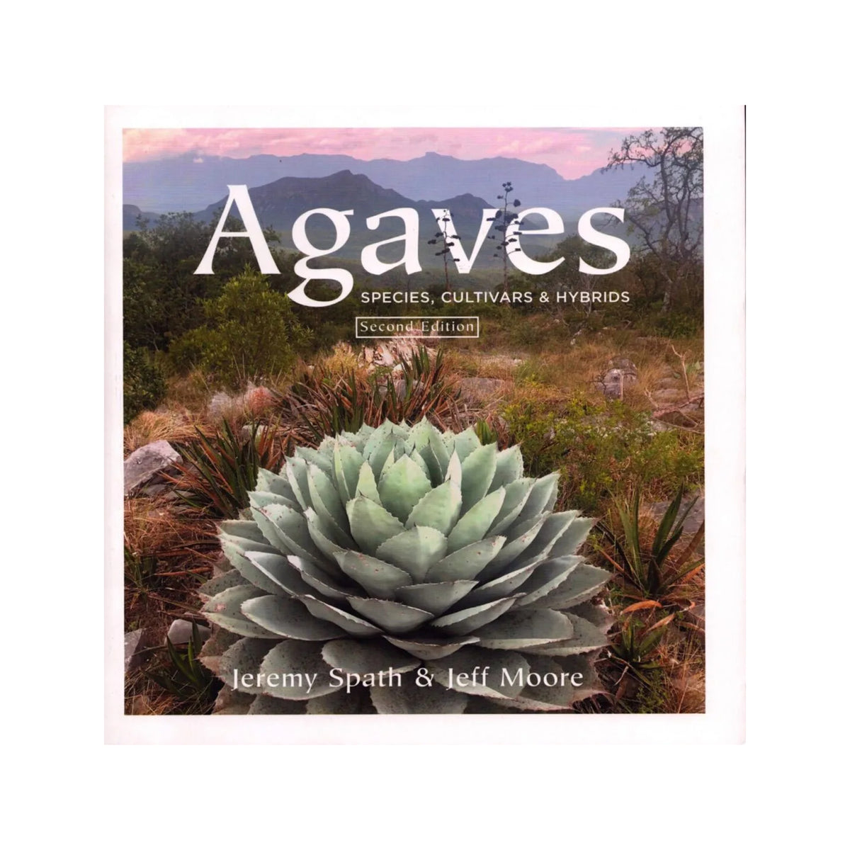 The front cover of the book 'Agaves: Species, Cultivars & Hybrids' Second Edition by Jeremy Spath & Jeff Moore, featuring a large agave plant in a desert landscape with mountains in the background.
