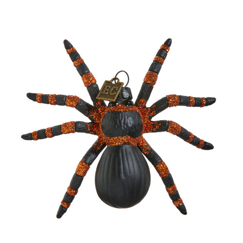 Look away arachnophobes! This spooky Tarantula-like spider has stripey, glittery legs and a matt-black body, and is ready to spin a web of Halloween hijinks! Hang by a window, place on a shelf, or as part of a terrifying tableau! Glass and resin ornament Dimension: 4" x 3.75"