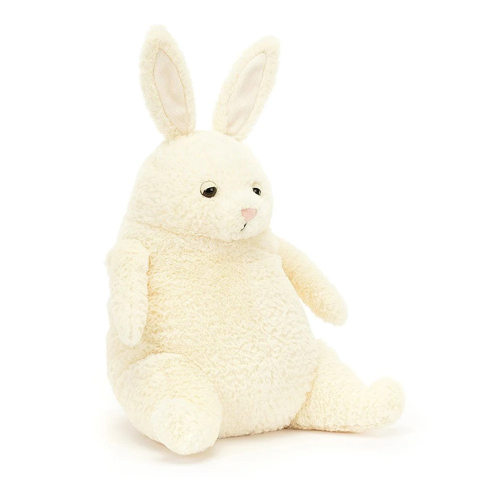Amore Bunny is one joyful pal, with a weighted base and textured vanilla fur. With chunky haunches, wee carrot arms, perky ears and a snuggly tum, this sleepy bunny is ready to close those suedette eyelids. Rumpled and soft, with a creamy bobtail, Amore Bunny is a calming friend. 10" x 7".  Suitable from birth. 