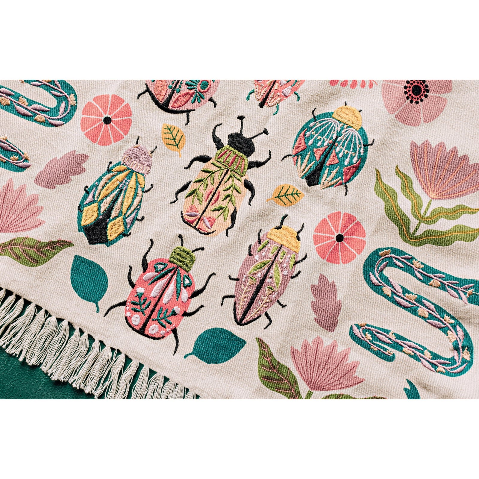 This richly embroidered tea towel features vibrantly decorated bugs, snakes and flowers. It is finished off with playful tassels to add a fun and functional flourish to your kitchen. Dimensions: W18 x L28in Material: Body: 100% Cotton Embroidery: 100% Polyester Care Instructions: Machine wash cold, hang to dry.