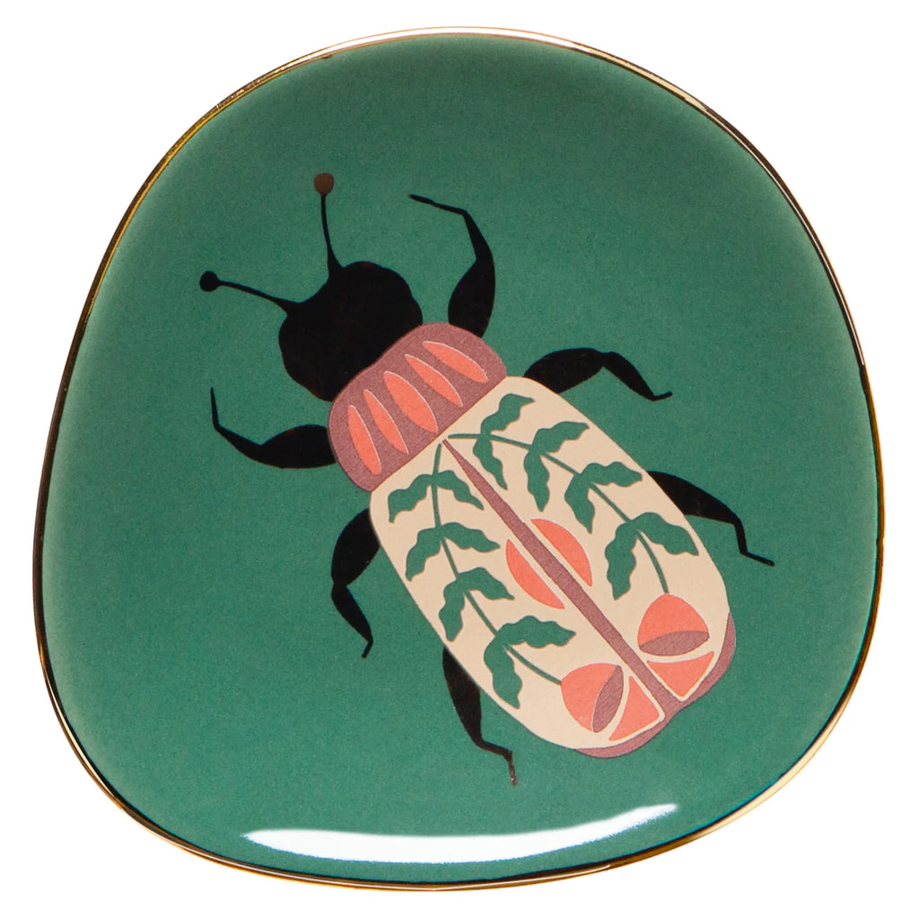 This cute little catch-all is beautifully decorated with a colorful beetle. The base is a jewel-tone emerald green, edged with gold metallic. Use for jewelry, coins, as a teabag holder and more! Ceramic trinket dish with gold metallic accents Dimensions: 5.5" x 0.5"