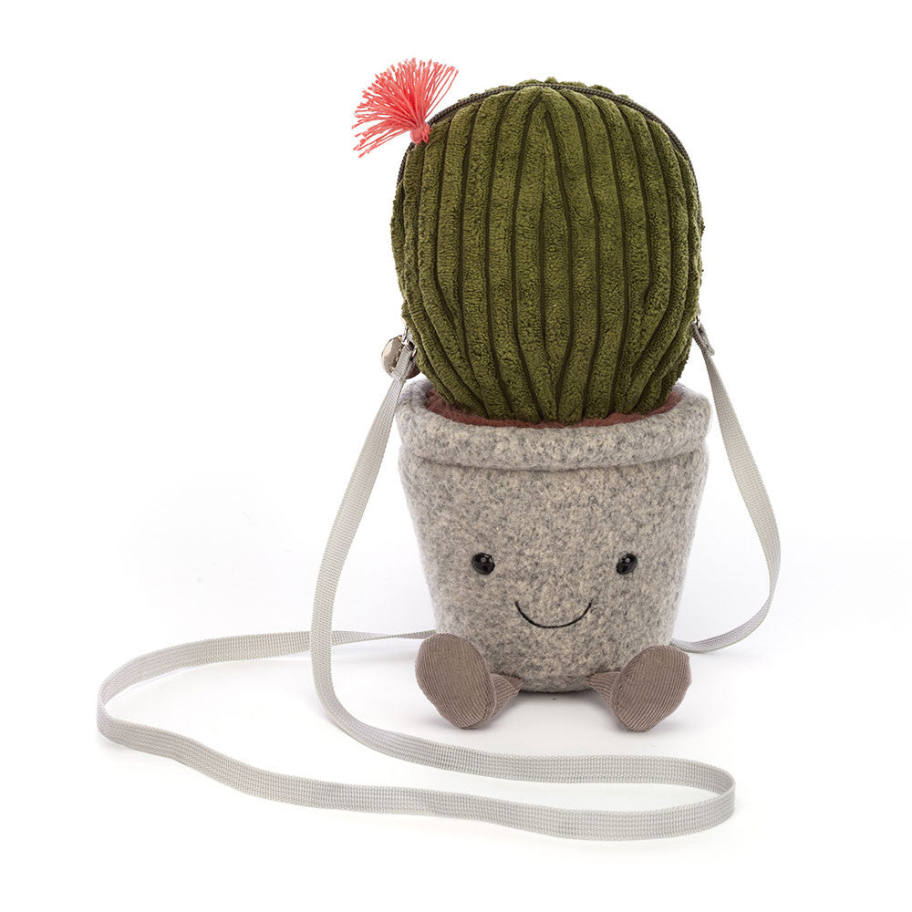 Amuseables Cactus Bag. With a felt pot, and a green cord barrel cactus which unzips. A pink tassel flower detail, and a cream cotton lining, webbed strap and silver zipper make this cross-body bag a playful nod to oasis style! Dimensions: 10.6in x 3.5in x 3.5in Sitting Height: 9in Strap Length: 46in. Not a toy, Suitable for 36 months plus.