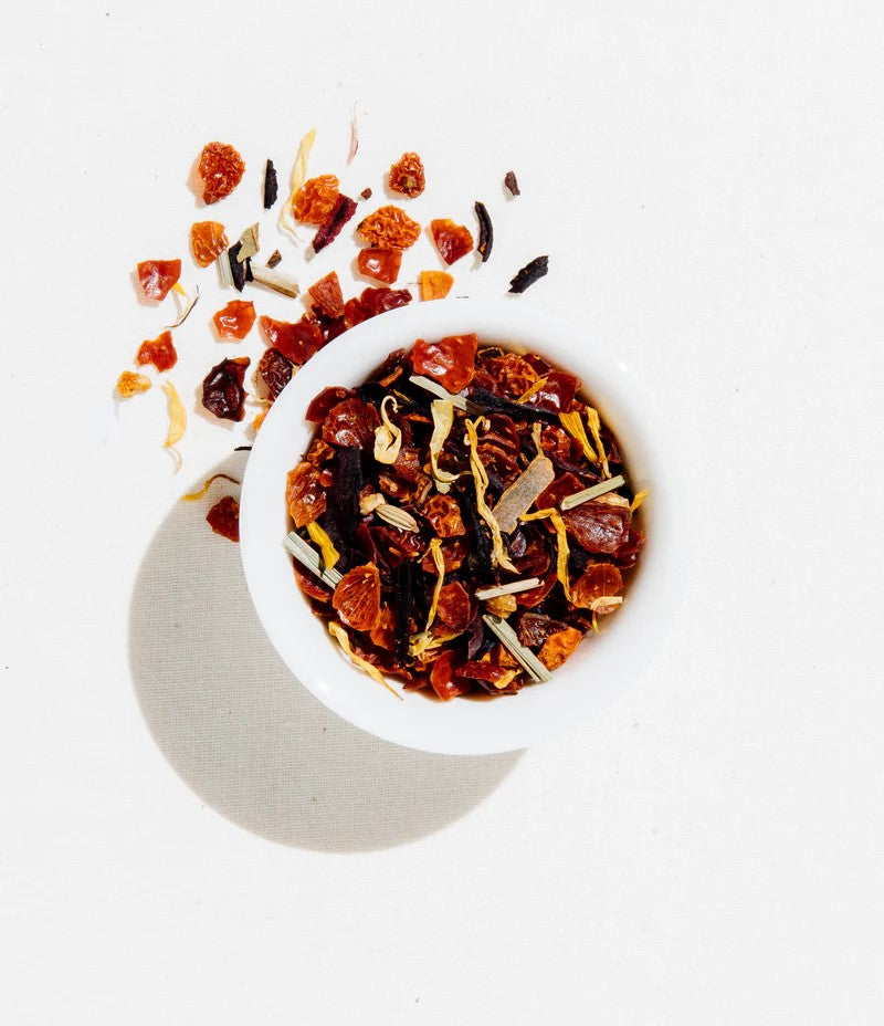 Tea canister labeled 'Apricot Escape' by 'Art of Tea' on a white background