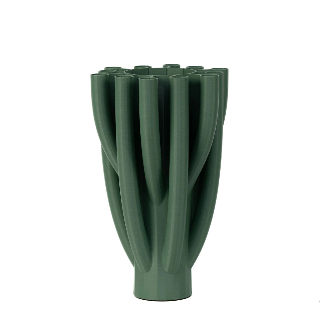 The Augustus Vase is a unique and sustainable addition to your home decor. 3D printed from plastic waste in Montreal, this vase is visually appealing and eco-friendly. Features a central opening for traditional arrangements, as well as smaller outlying openings for creative and stunning masterpieces. 12" x 7.5".