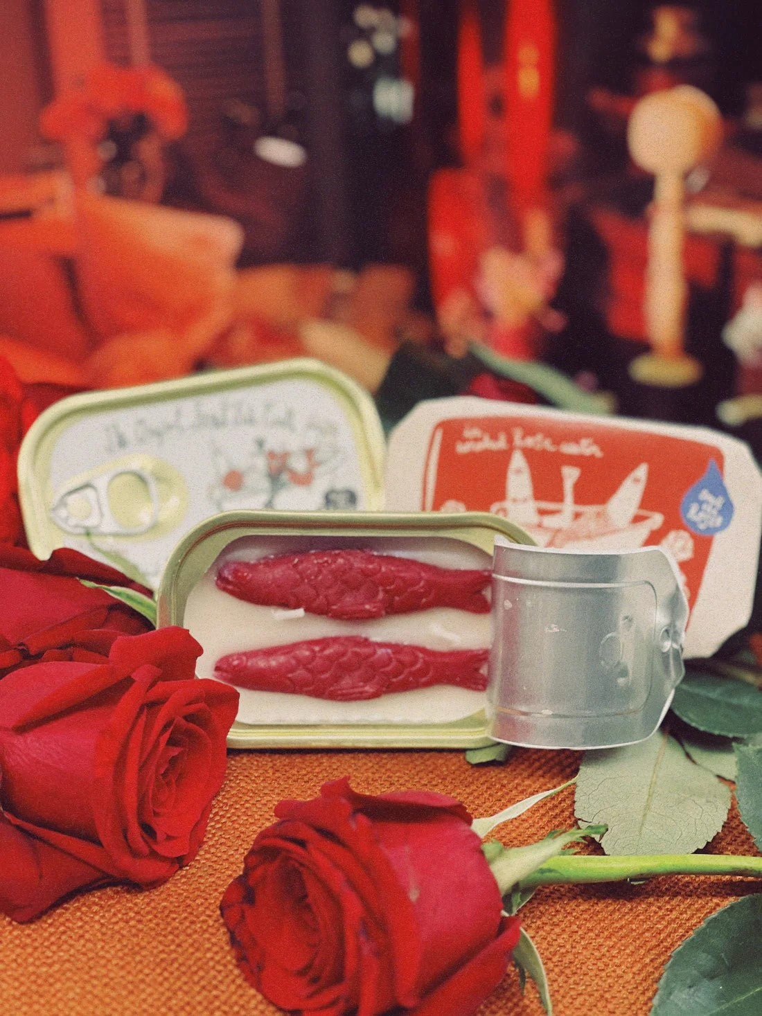 Discover this enchanting Smoked Rose Water candle, a unique blend of rustic and floral aromas. Housed in a whimsical sardine tin with delicate sardine-shaped candles inside with added shimmer, it combines the fresh fragrance of roses with the comforting scent of a campfire. Perfect for creating a serene ambiance or as a thoughtful gif